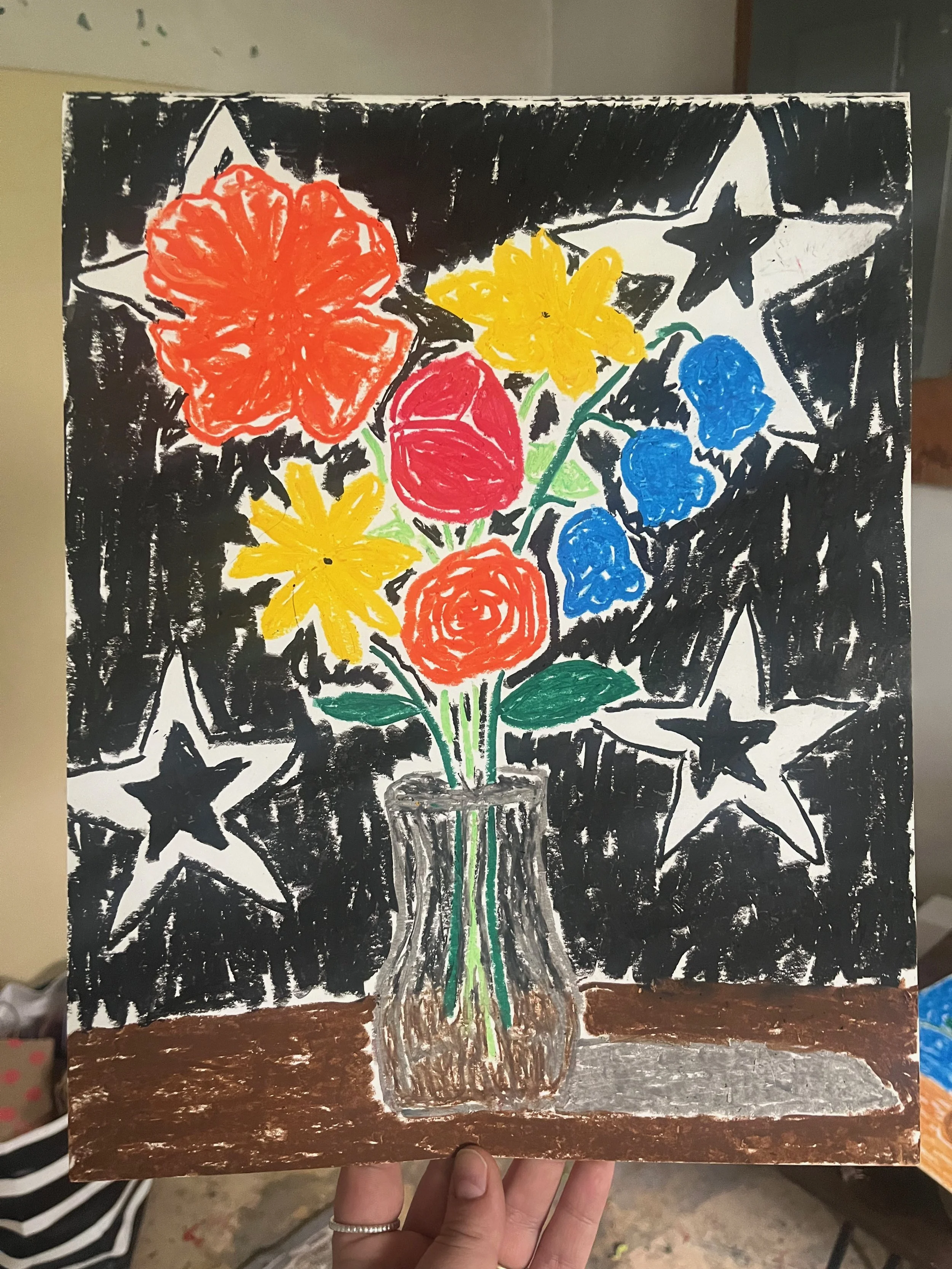 Drawing of a colorful flower bouquet in a jar, set against a black starry background with white stars. The bouquet includes yellow, red, and blue flowers, with green leaves, on a brown table.