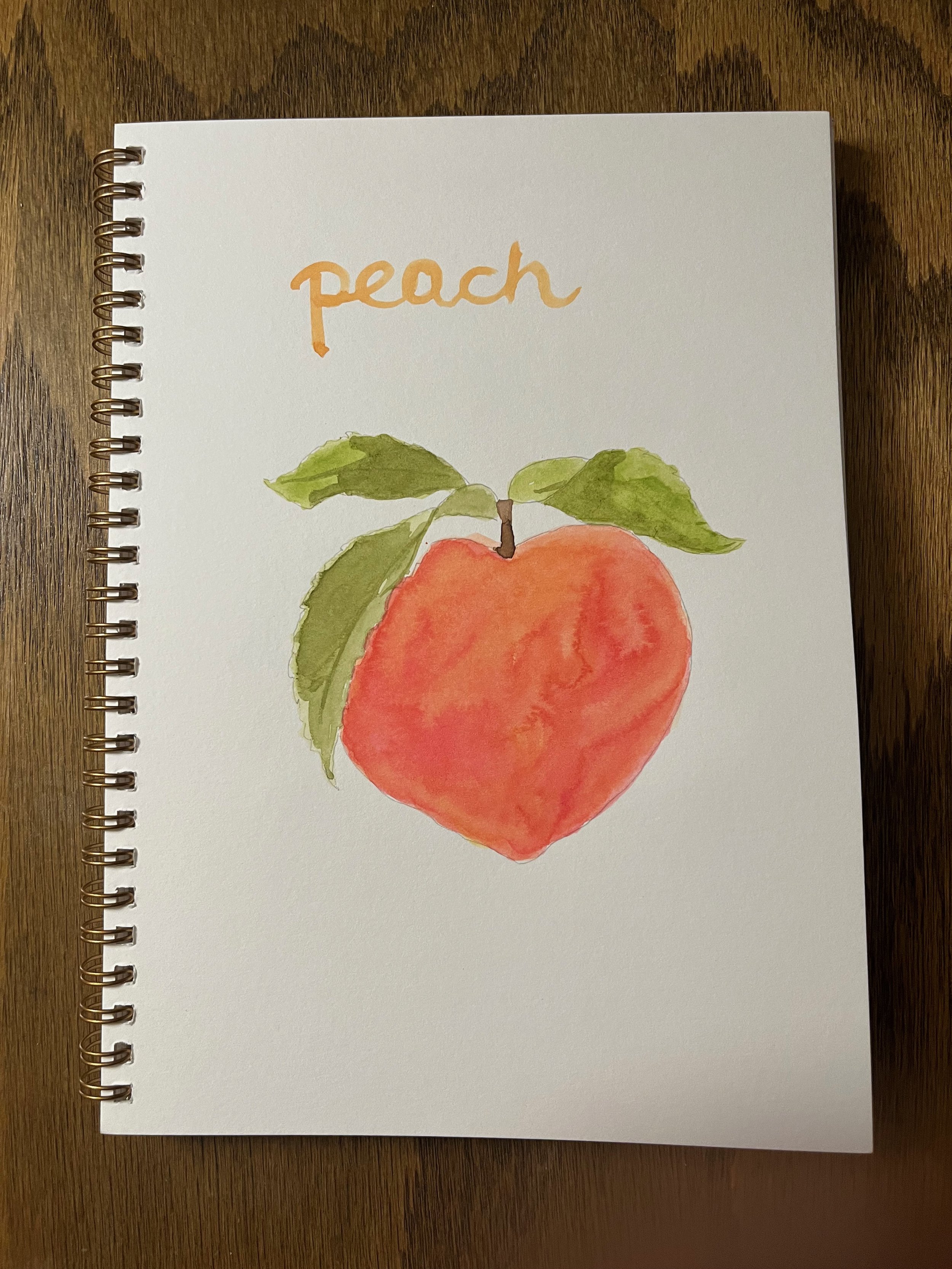 Watercolor painting of a peach with green leaves and the word 'peach' written above in orange.