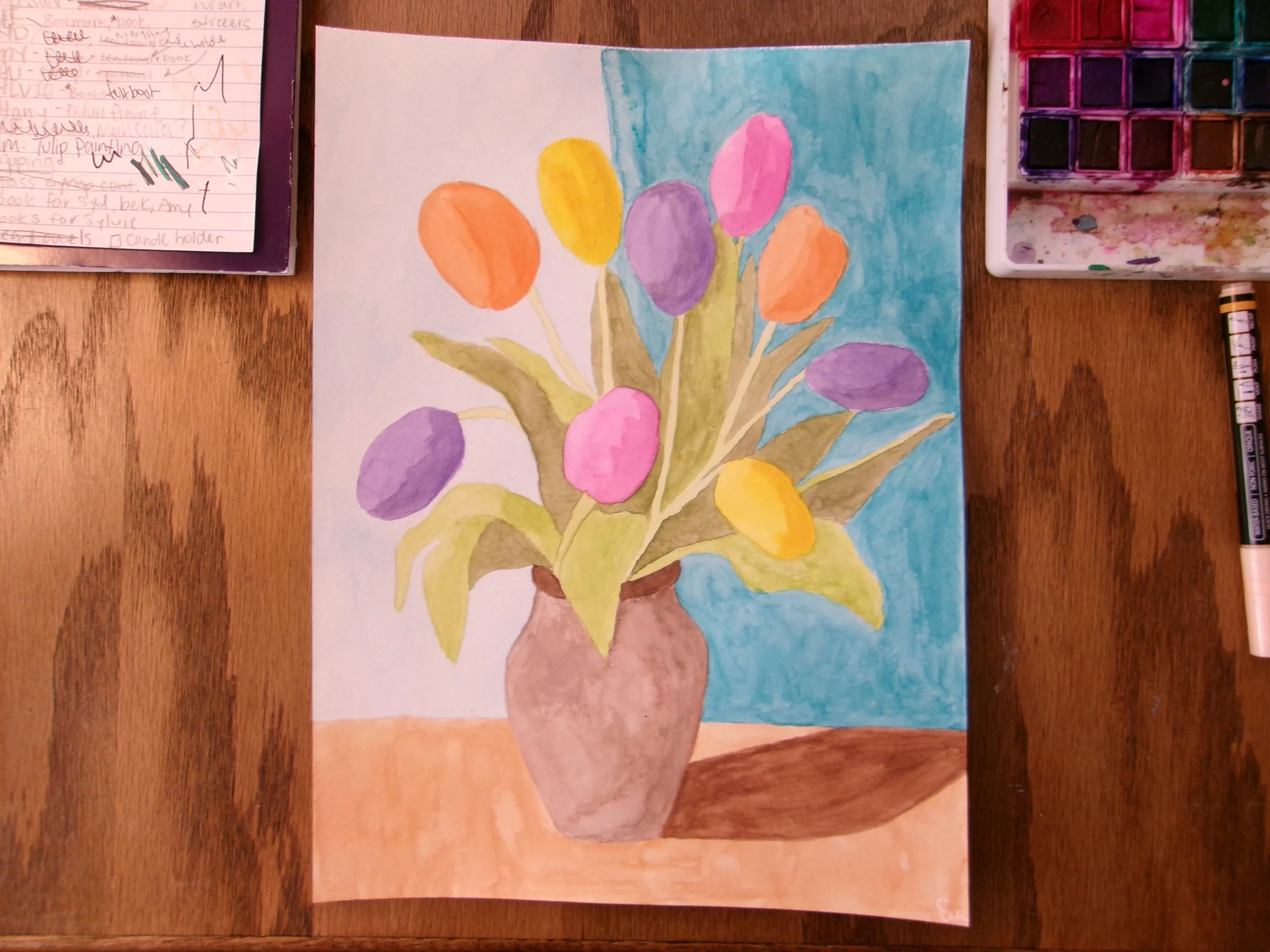 Colorful watercolor painting of a vase with multicolored flowers, set on a table with a background of sky blue.
