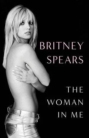 Black and white cover photo of Britney Spears, topless, with her arms crossed over her chest, and text that reads "Britney Spears The Woman In Me."