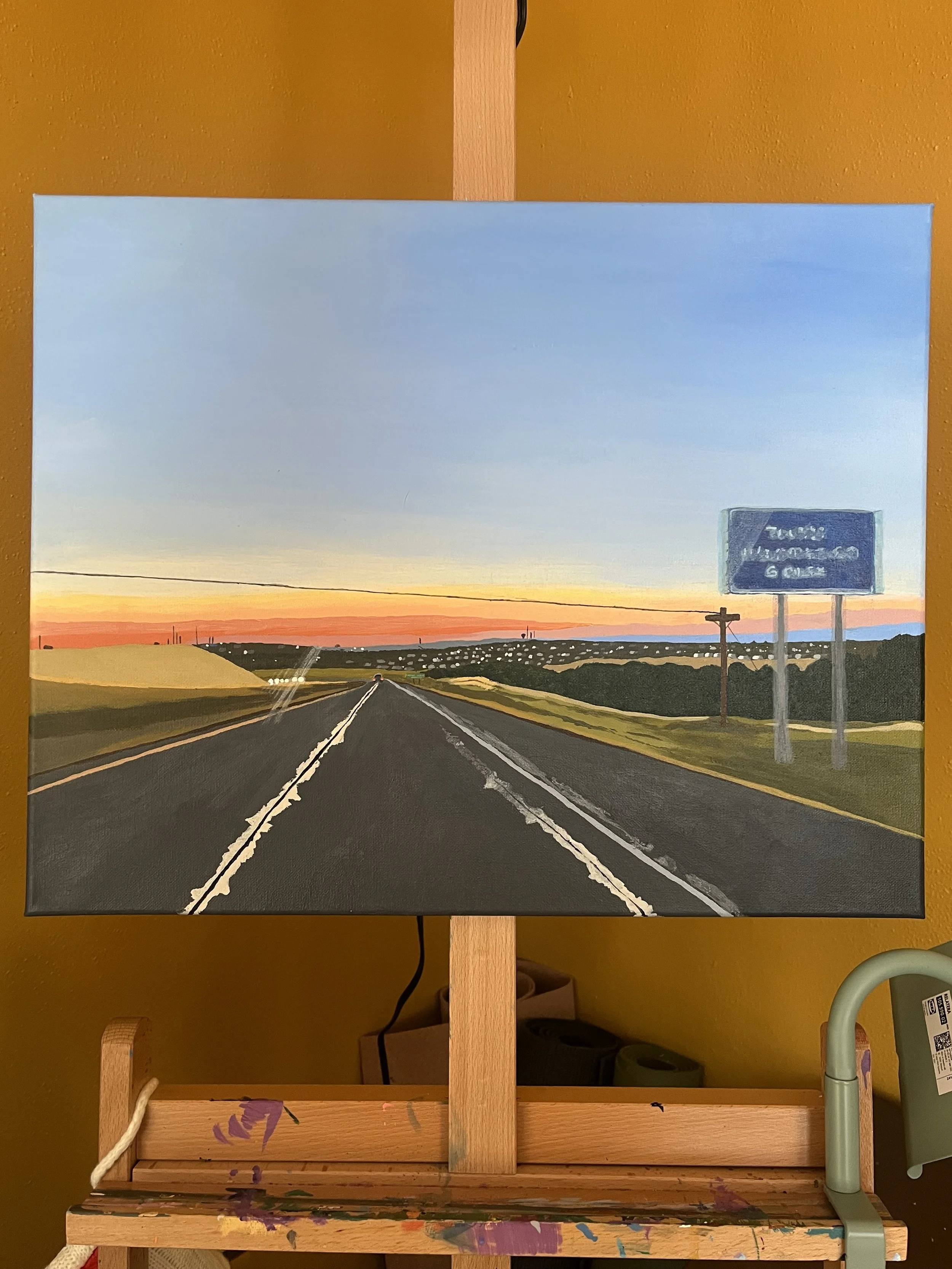 Painting of a road at sunset with a blue sky, distant hills, and a signpost on the right side.