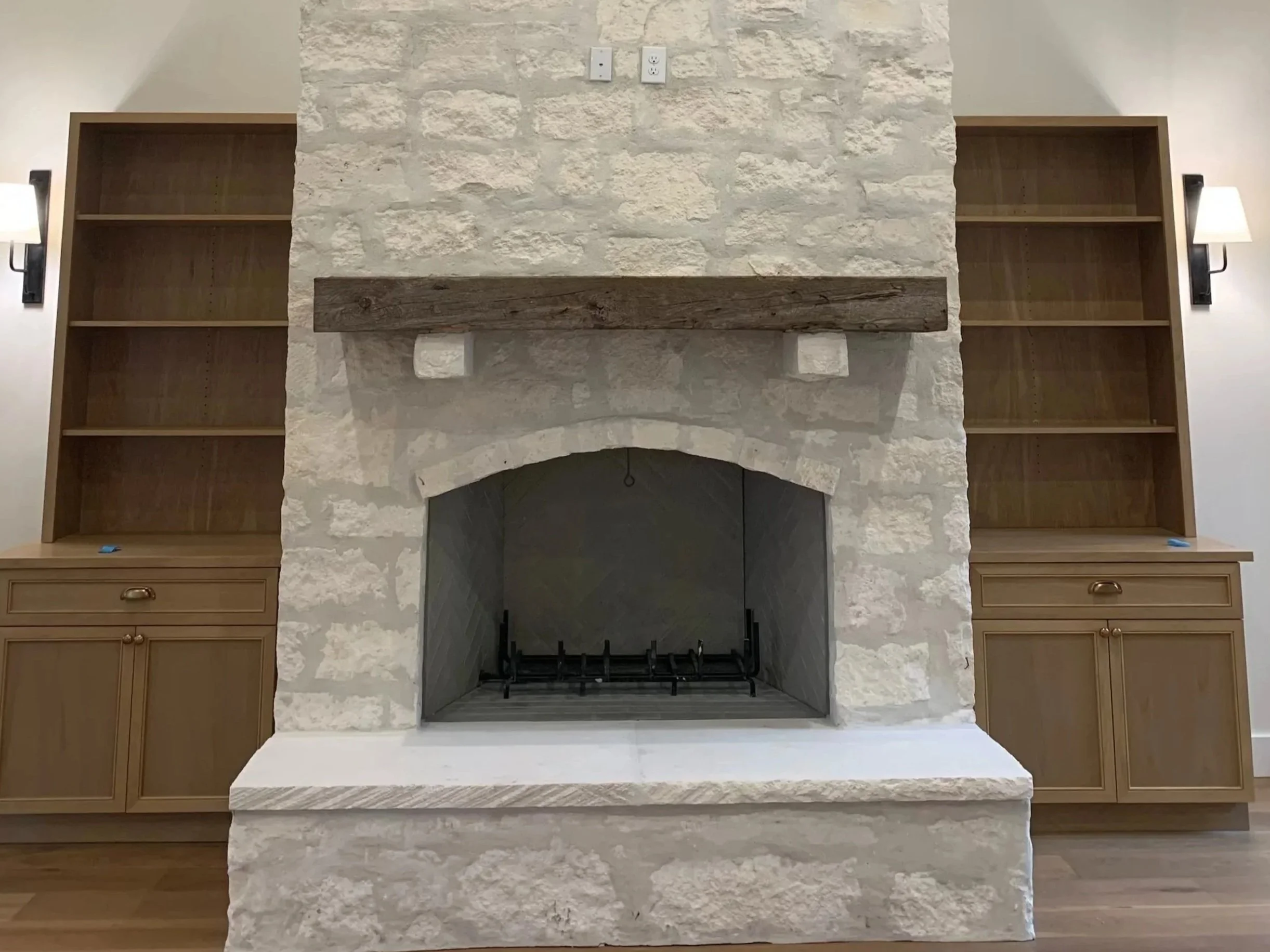 Austin stone fireplace with built-in cabinets on the sides