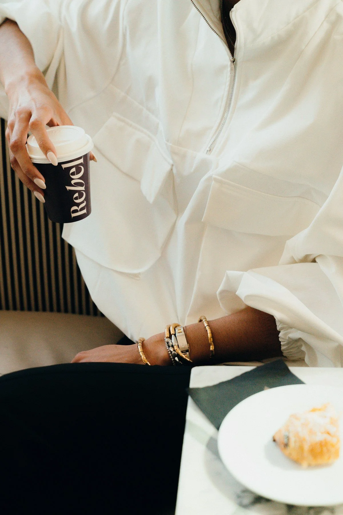 Rebel-branded coffee cup in a lifestyle setting