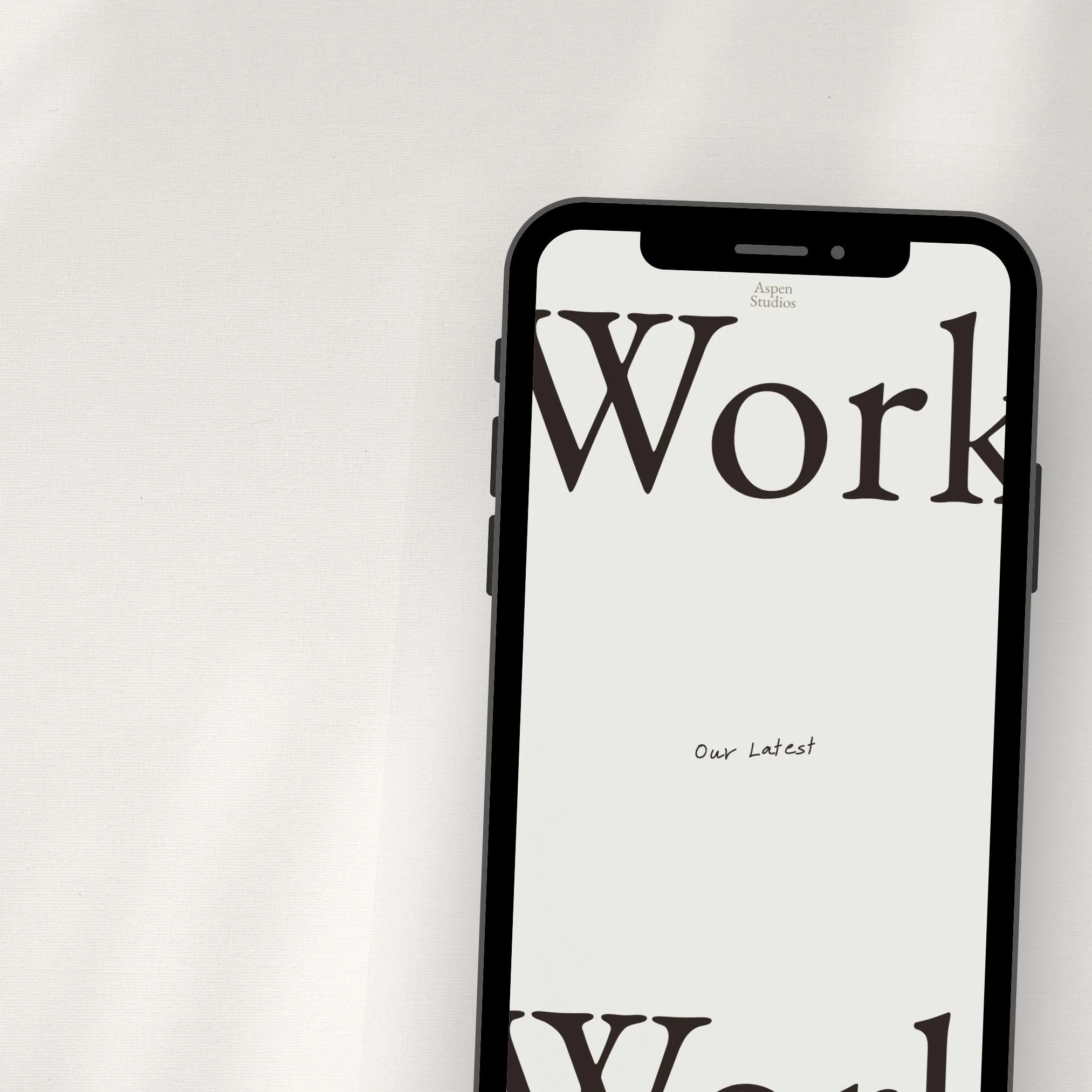A smartphone displaying a website with the word 'Work' in large font, and smaller text below that says 'Our Latest', against a plain background.