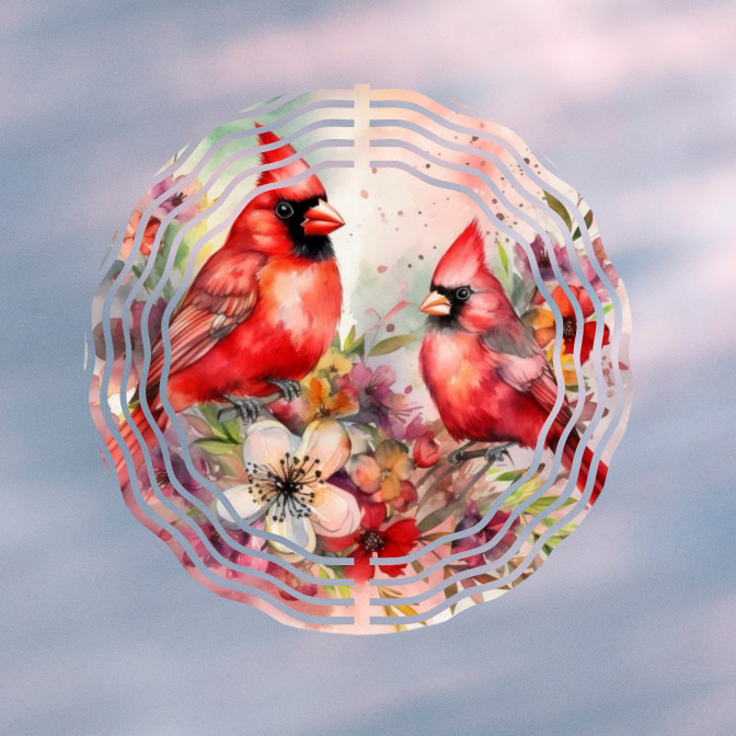 Digital artwork of two cardinals, one male with a crest and one female without, perched on branches with flowers, framed by a decorative circular pattern, against a cloudy sky background.