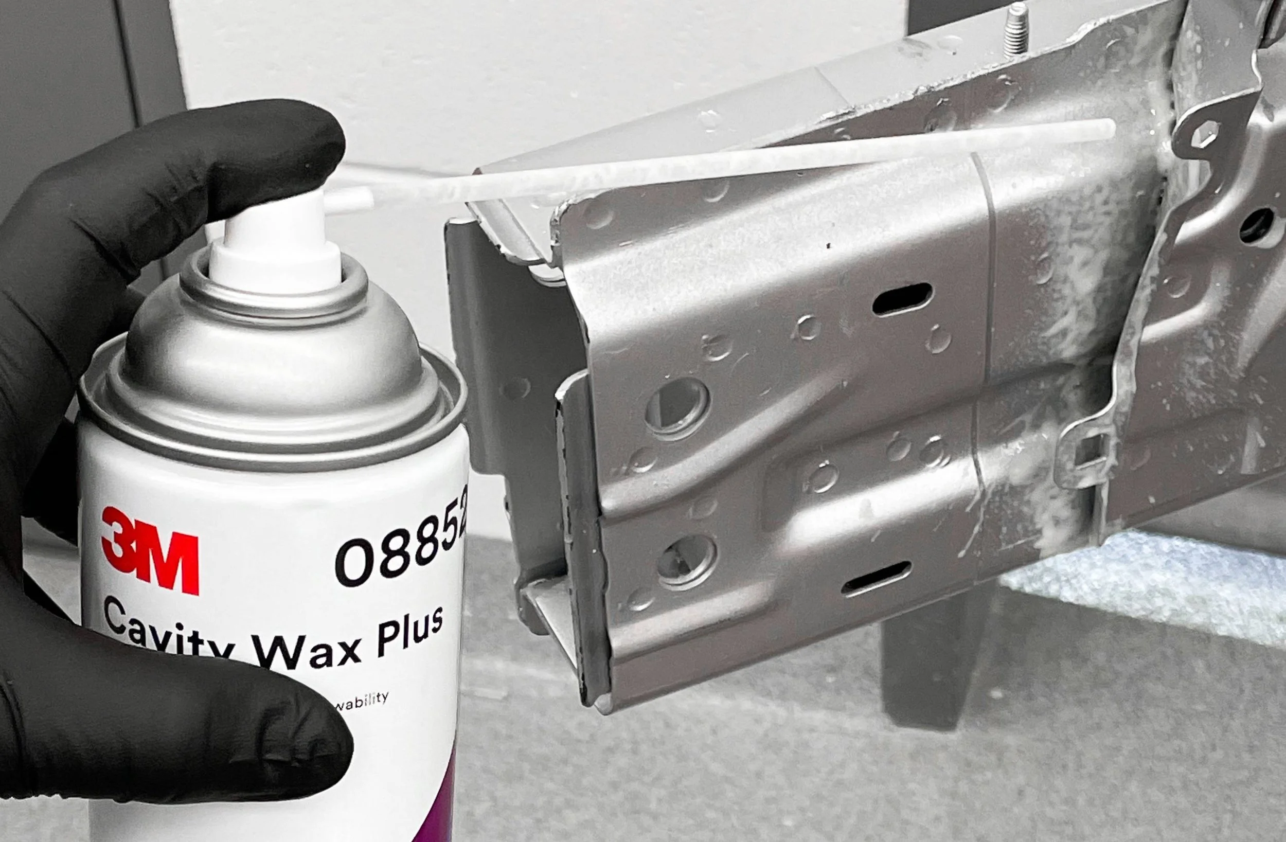 A can of 08852 3M Cavity Wax is applied within a seam sealing it from corrosion.