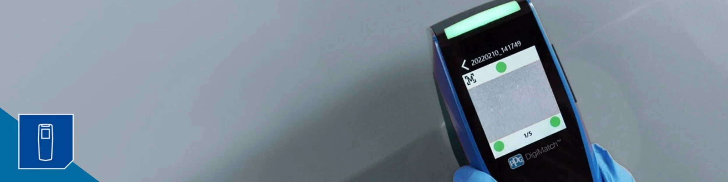 A PPG Digimatch spectrophotometer takes a reading of a silver vehicle in order to match the paint color.