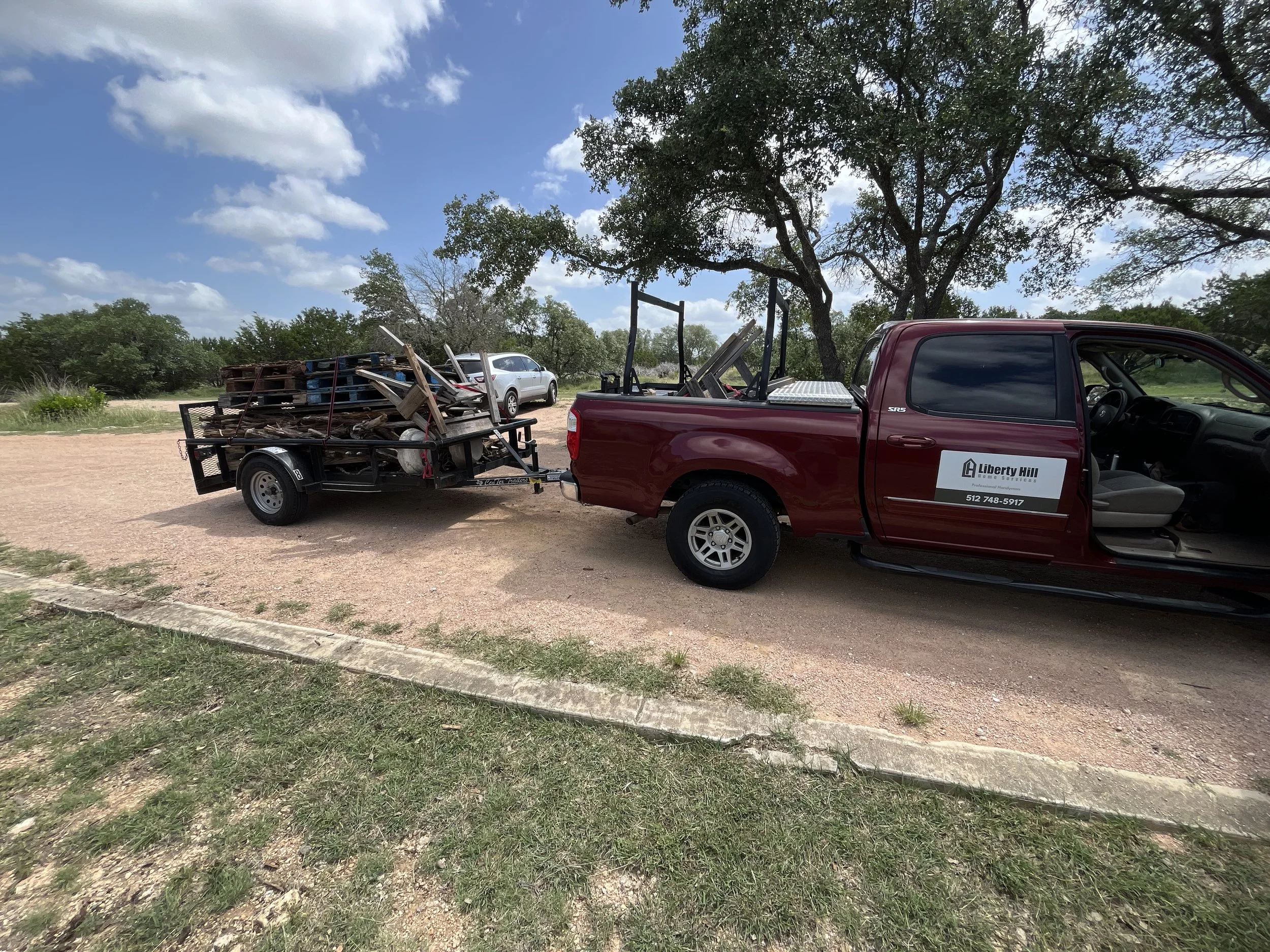 Truck and trailer performing junk removal