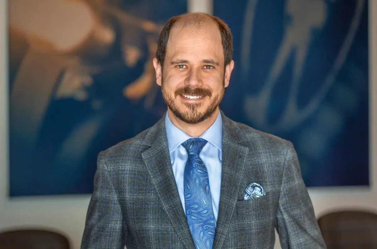 Award-winning filmmaker Nathan Havey in front of blue background