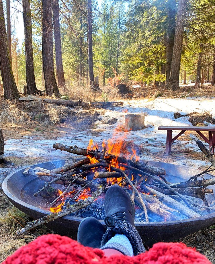 Relaxing by the fire at the campsite