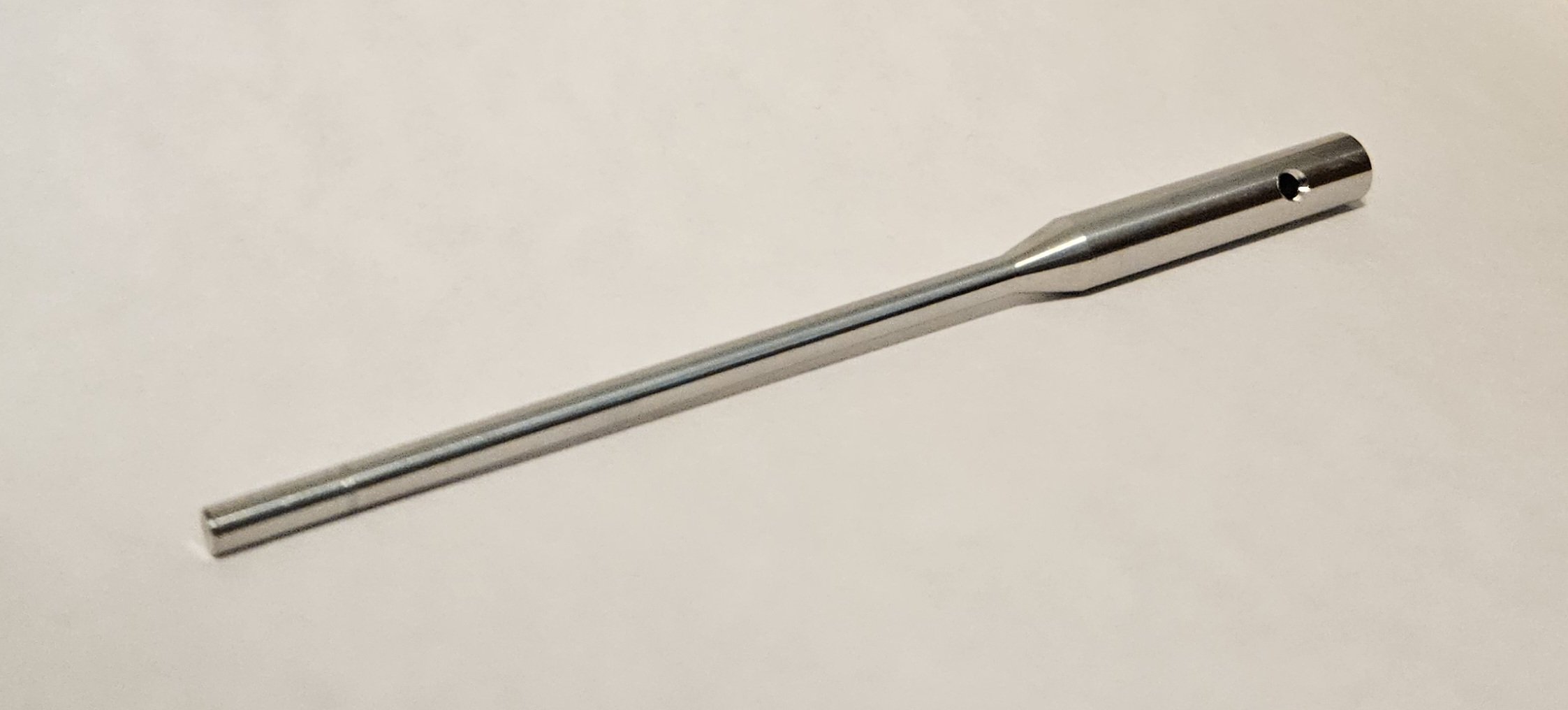 Small diameter precision shaft manufactured on a Swiss-type CNC lathe with excellent straightness and surface finish. Features precision turned diameters and cross-hole machining.