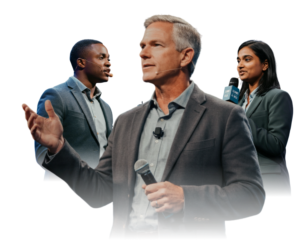 Three people at a conference or public speaking event, with two men and one woman, all wearing business suits, holding microphones, and engaged in conversation.