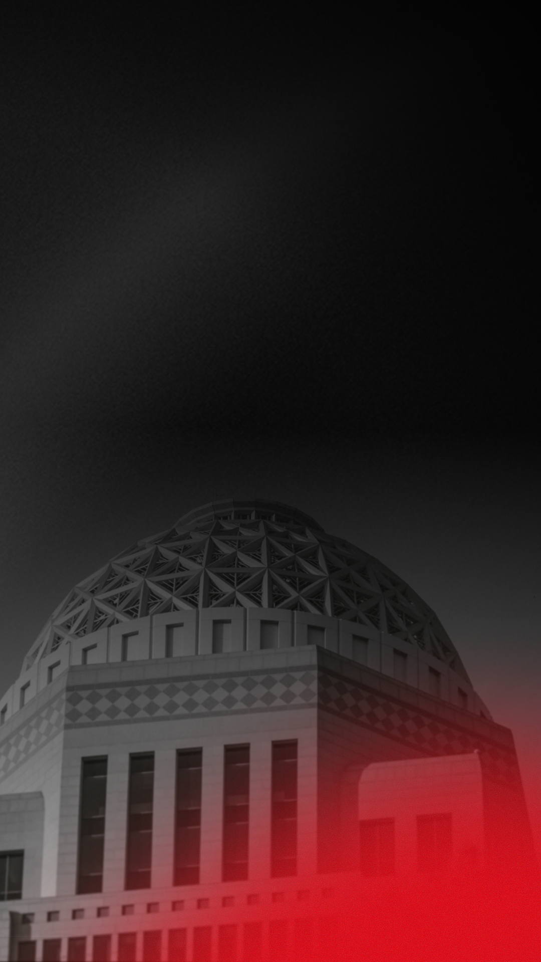 The image depicts a large, dome-shaped building with a patterned exterior, with a gradient overlay of red at the bottom and a dark sky above.
