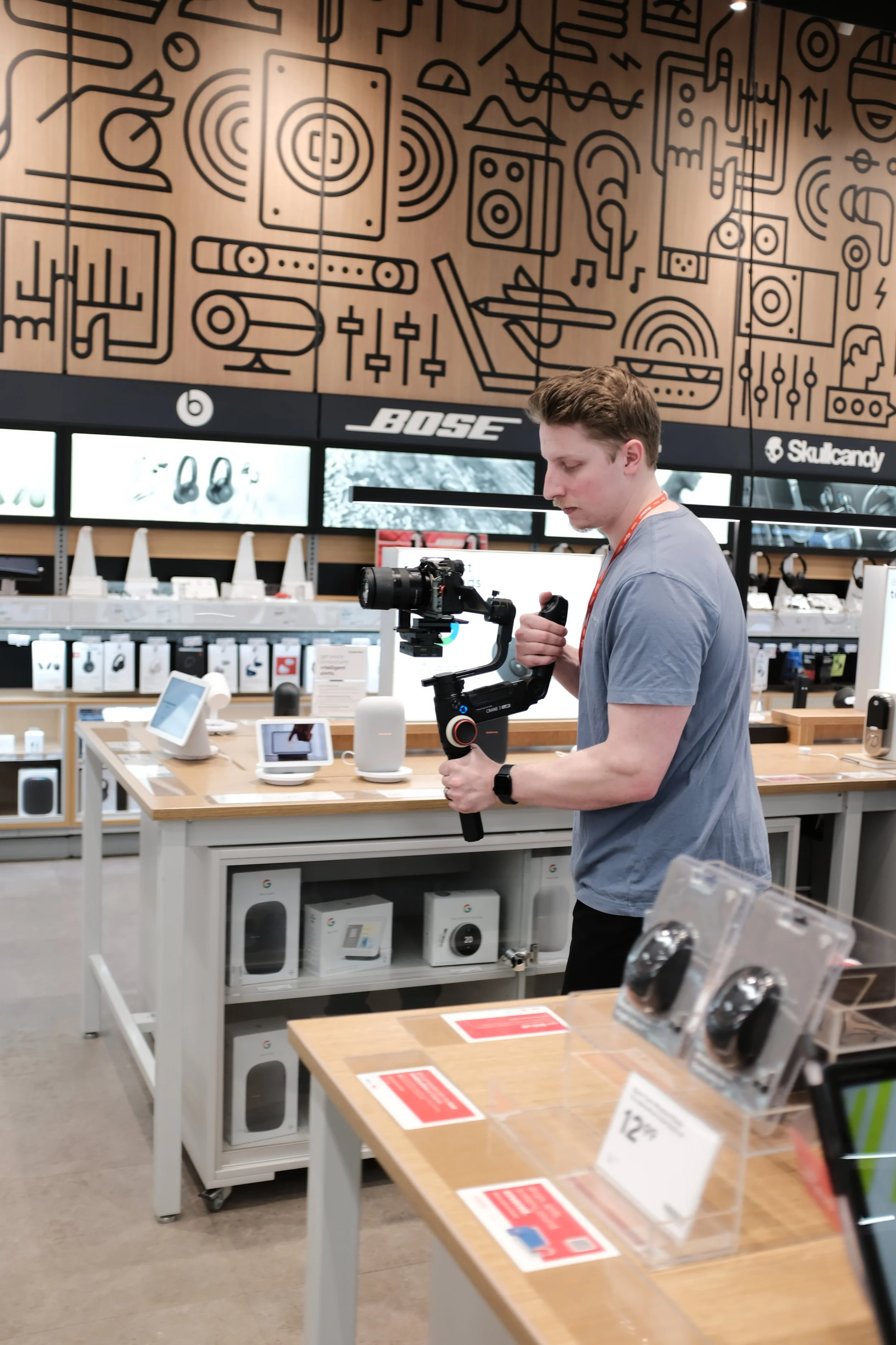 Person holding camera stabilizer in electronics store
