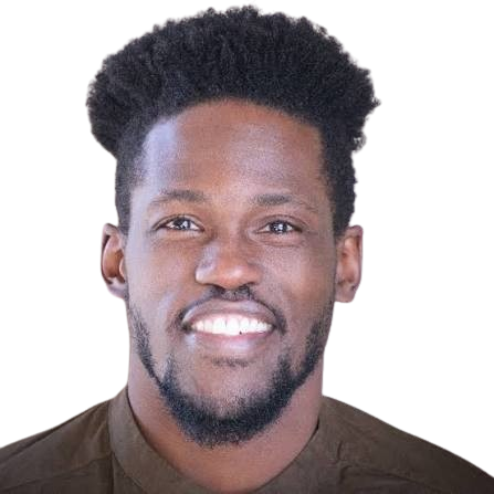 Portrait of a young Black man with a big smile, short curly hair, and a beard, wearing a dark shirt.