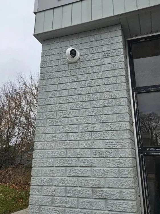 Exterior turret camera mounted on the corner of a commercial building