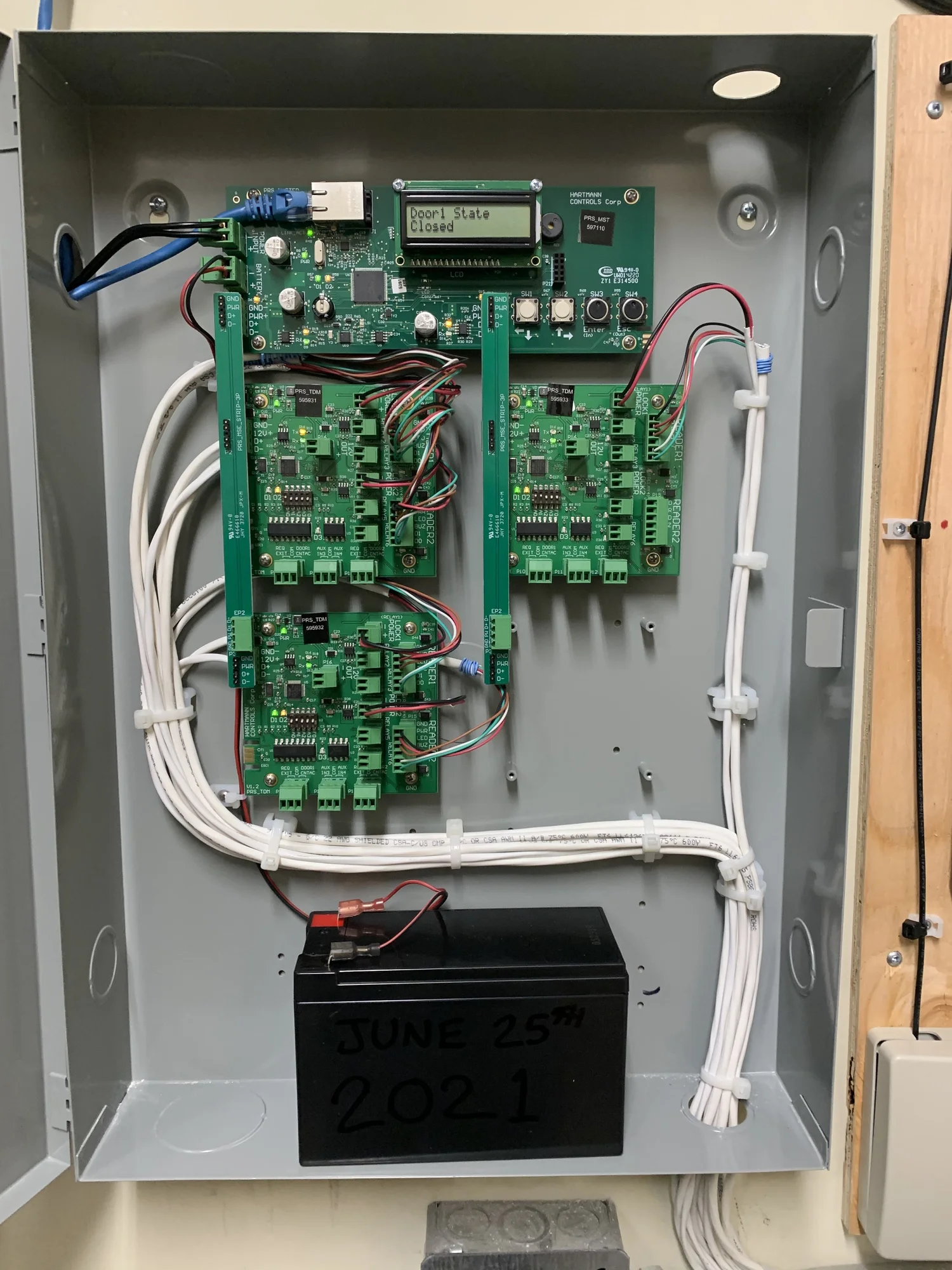 Card access controller boards wired inside a metal enclosure