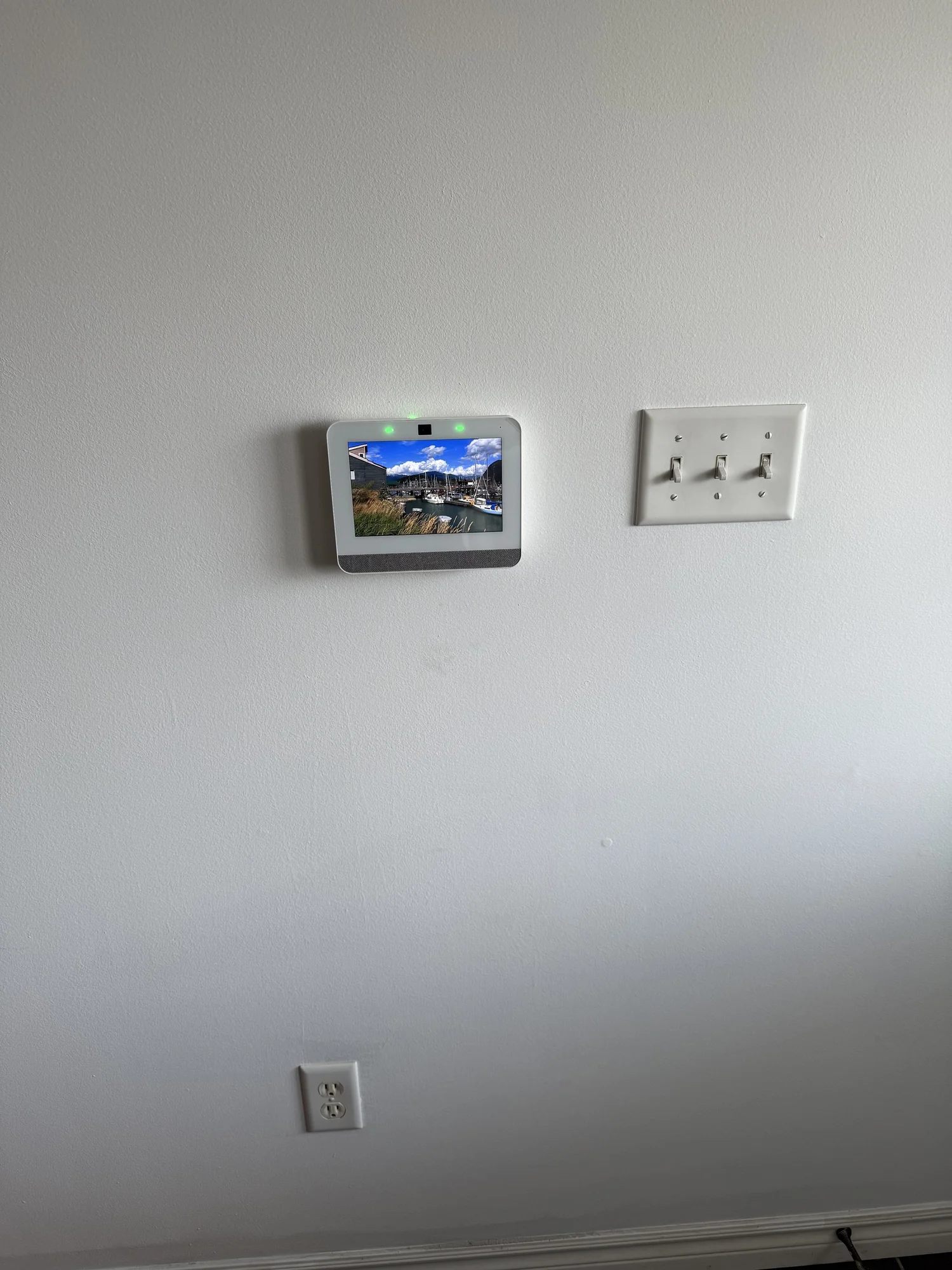 Alarm keypad panel installed flush on a finished hallway wall