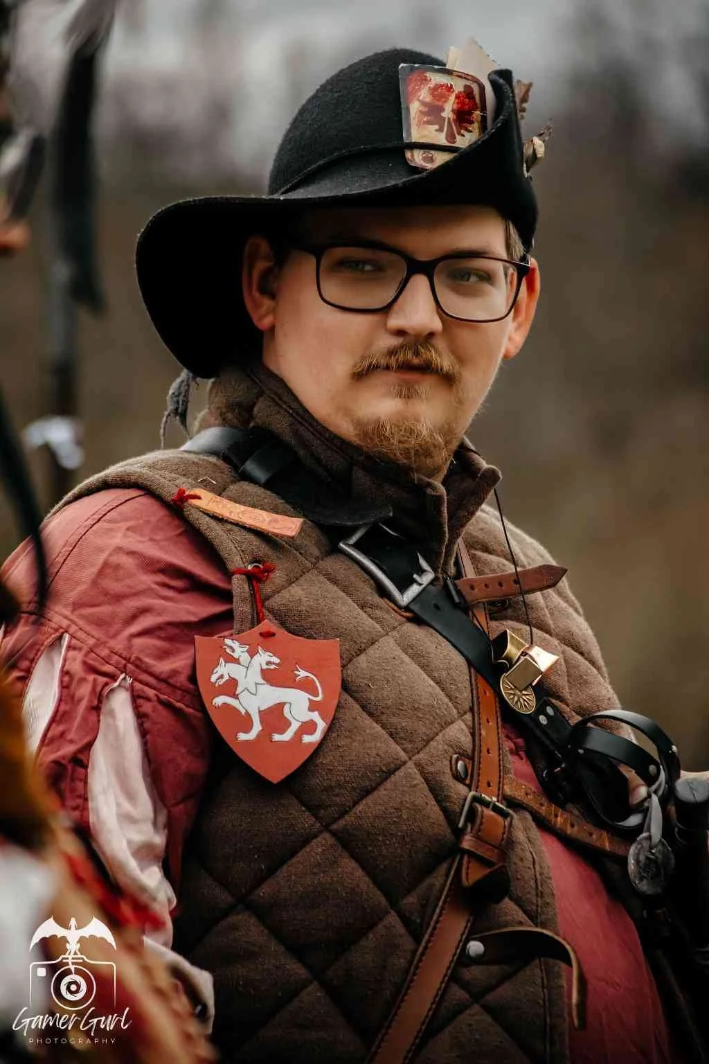 Group of people dressed in medieval fantasy costumes, with a forest in the background.
