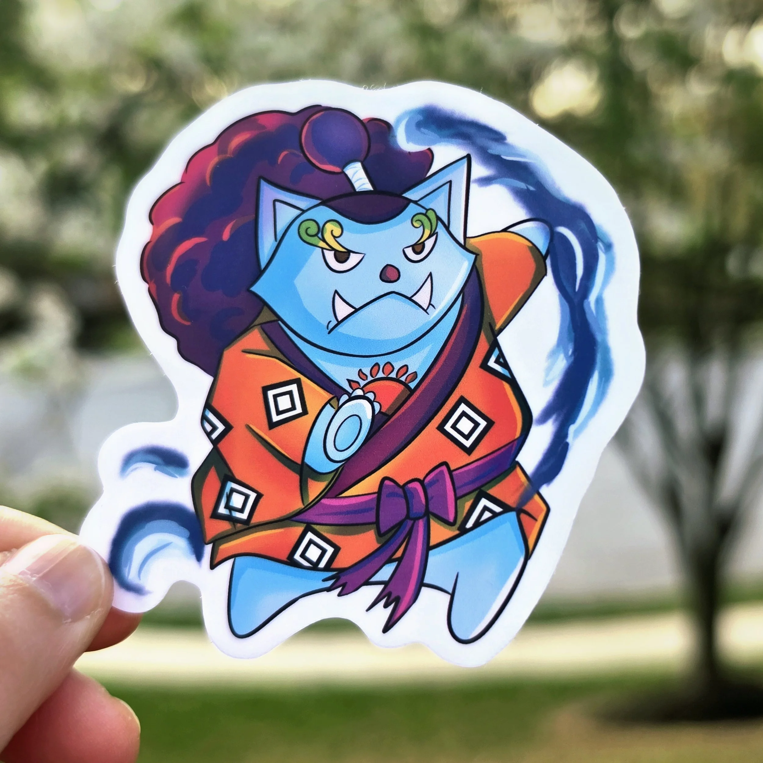 The Helmsman (Jinbei): A sturdy, blue cat sticker inspired by Jinbei, wearing a traditional orange kimono in a powerful martial arts stance.