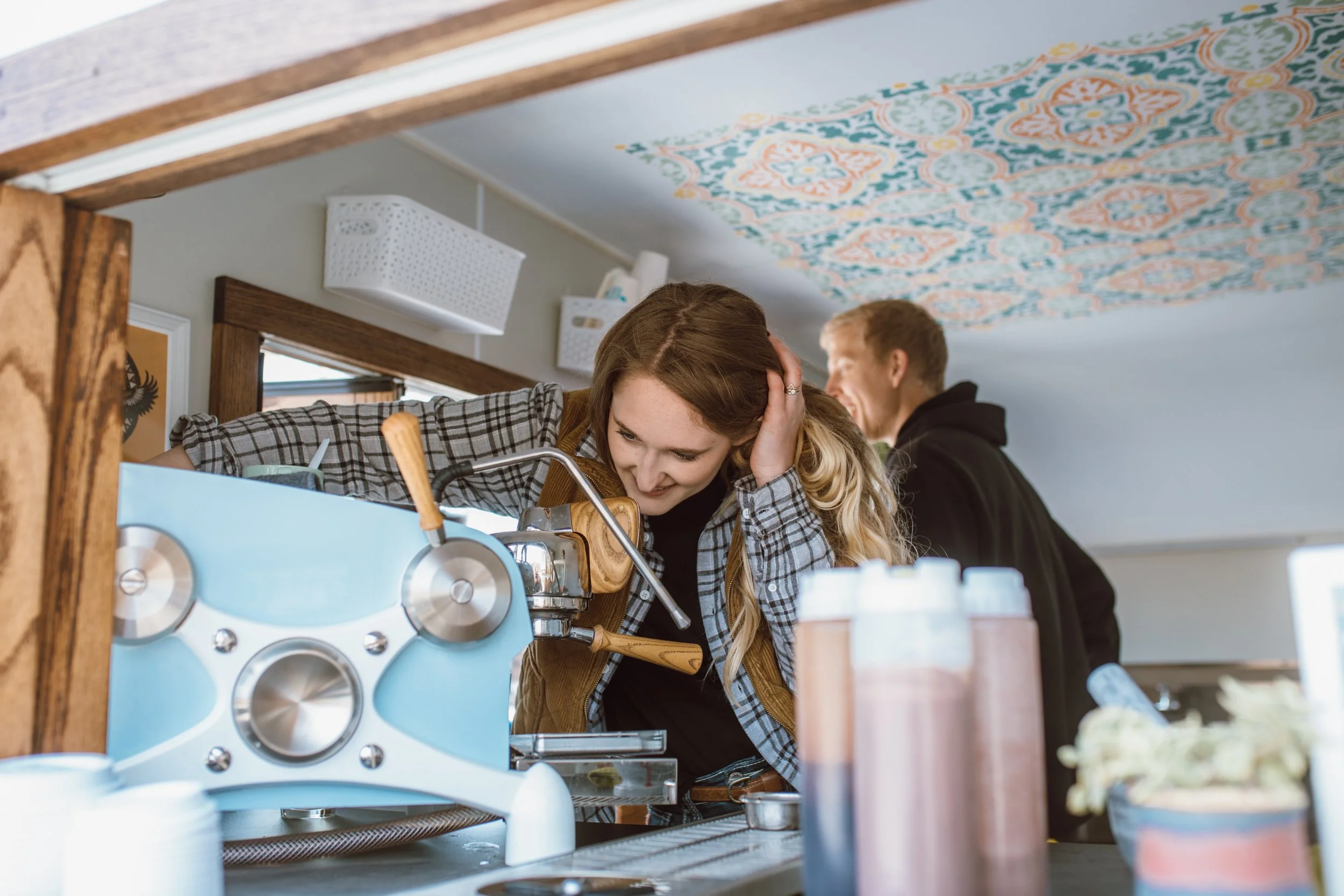 Christine Clutton in her coffee camper with husband Jon making coffee on Slayer Espresso