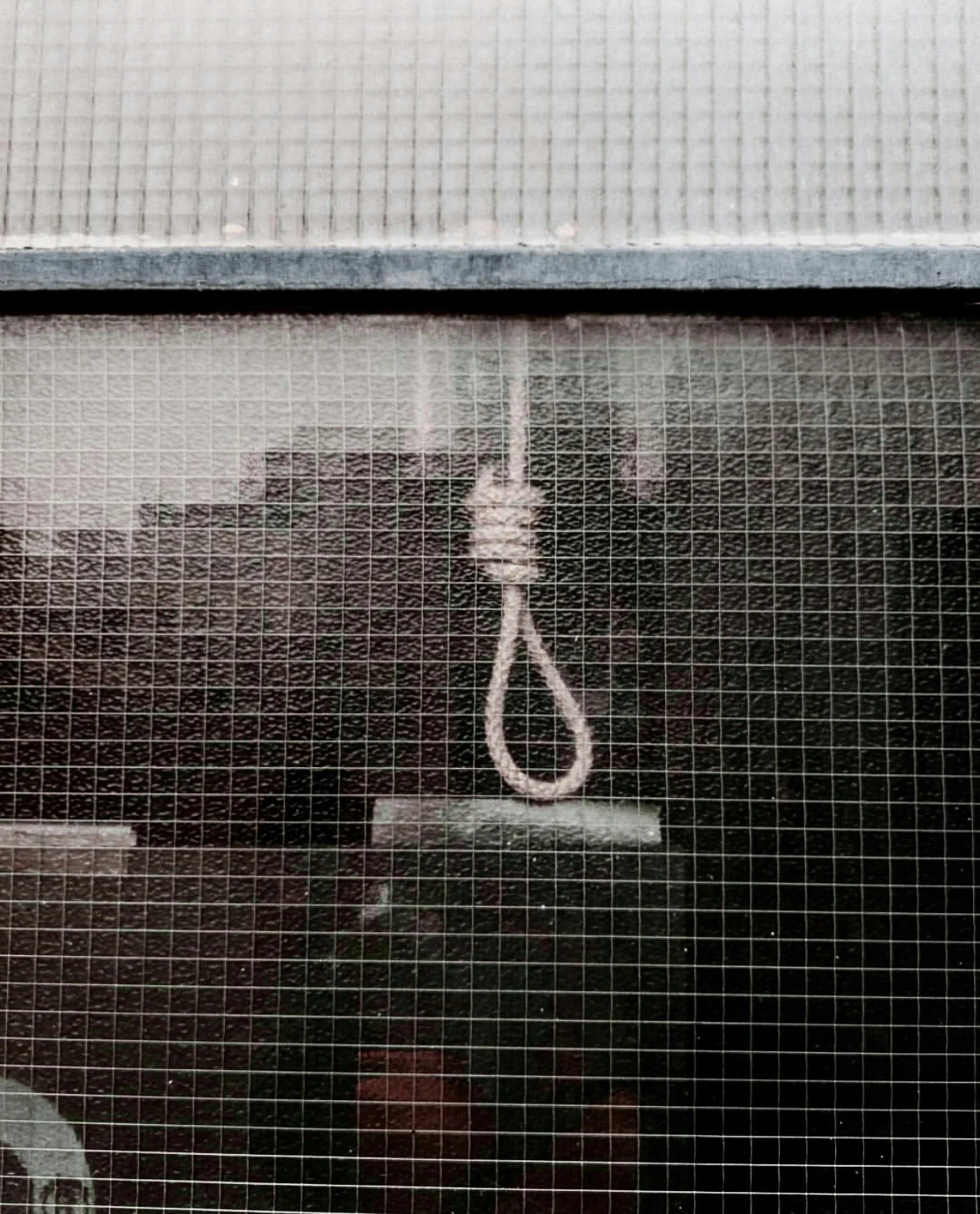 A window with a chalk drawing of a noose.