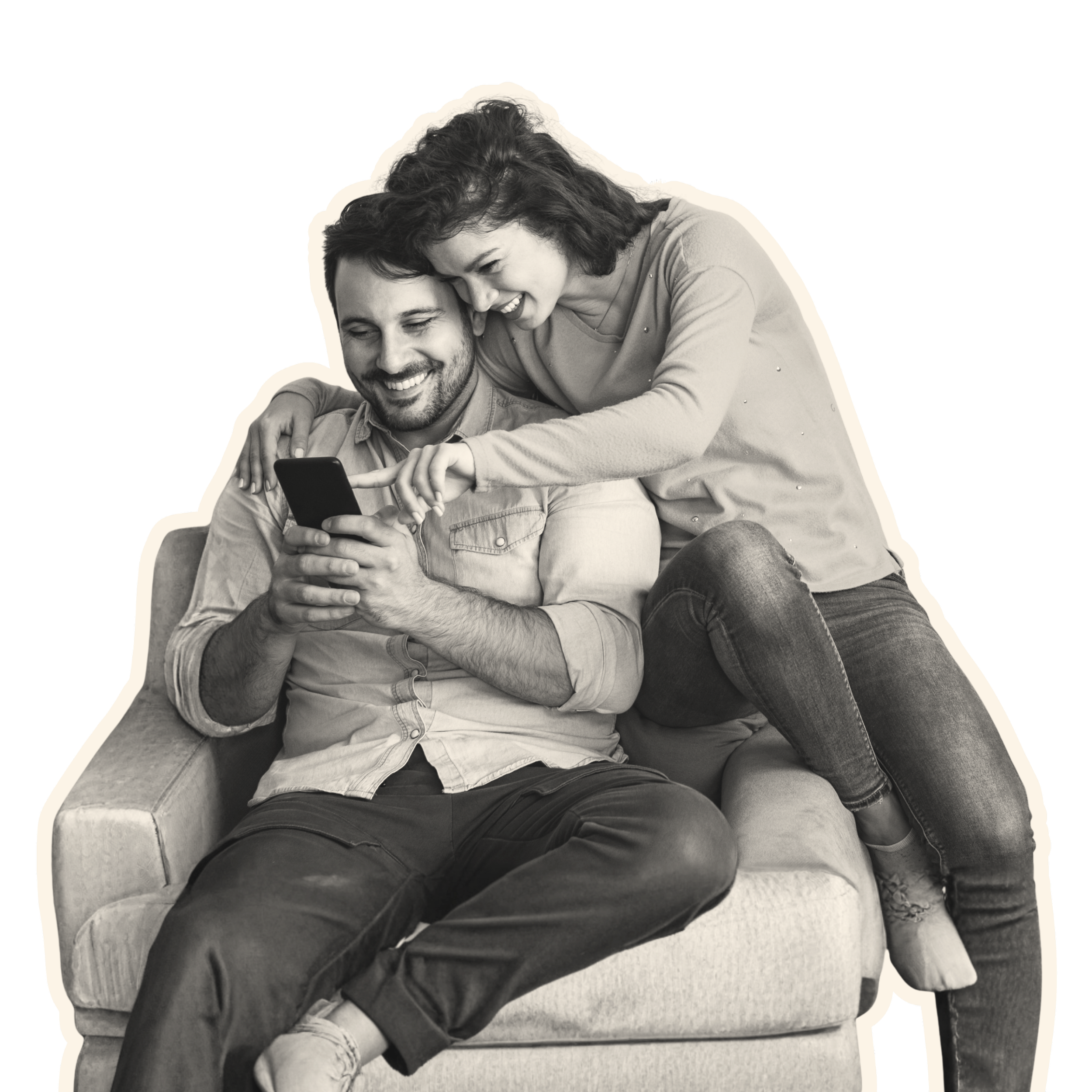 A black and white photo of a man and woman sitting on a sofa, looking at a smartphone together. The woman is leaning over the man, both smiling and sharing a moment of enjoyment.