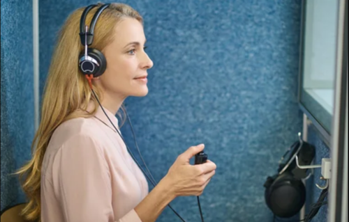 Audiologist examining a patient's ear