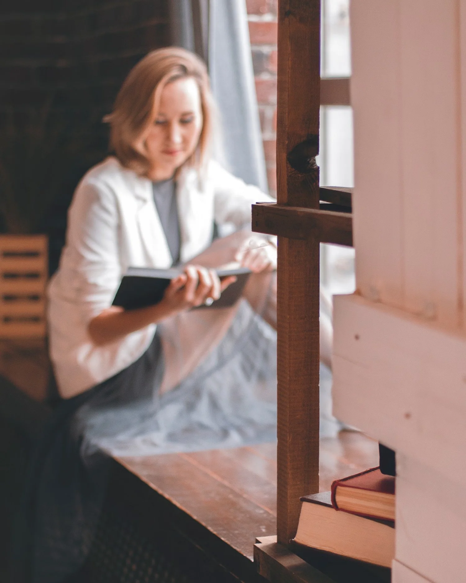 Person reading quietly by a window