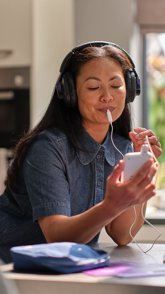Person using Lenire tinnitus treatment at home