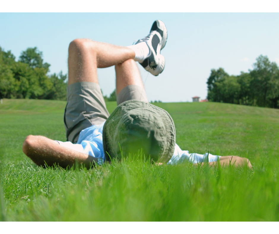 Person relaxing outdoors on the grass