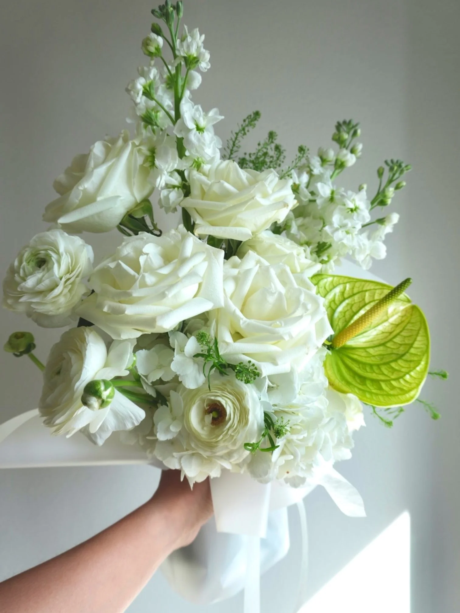Luxury white flower bouquet with ranunculus and anthurium in natural light _ DTLA florist.jpeg