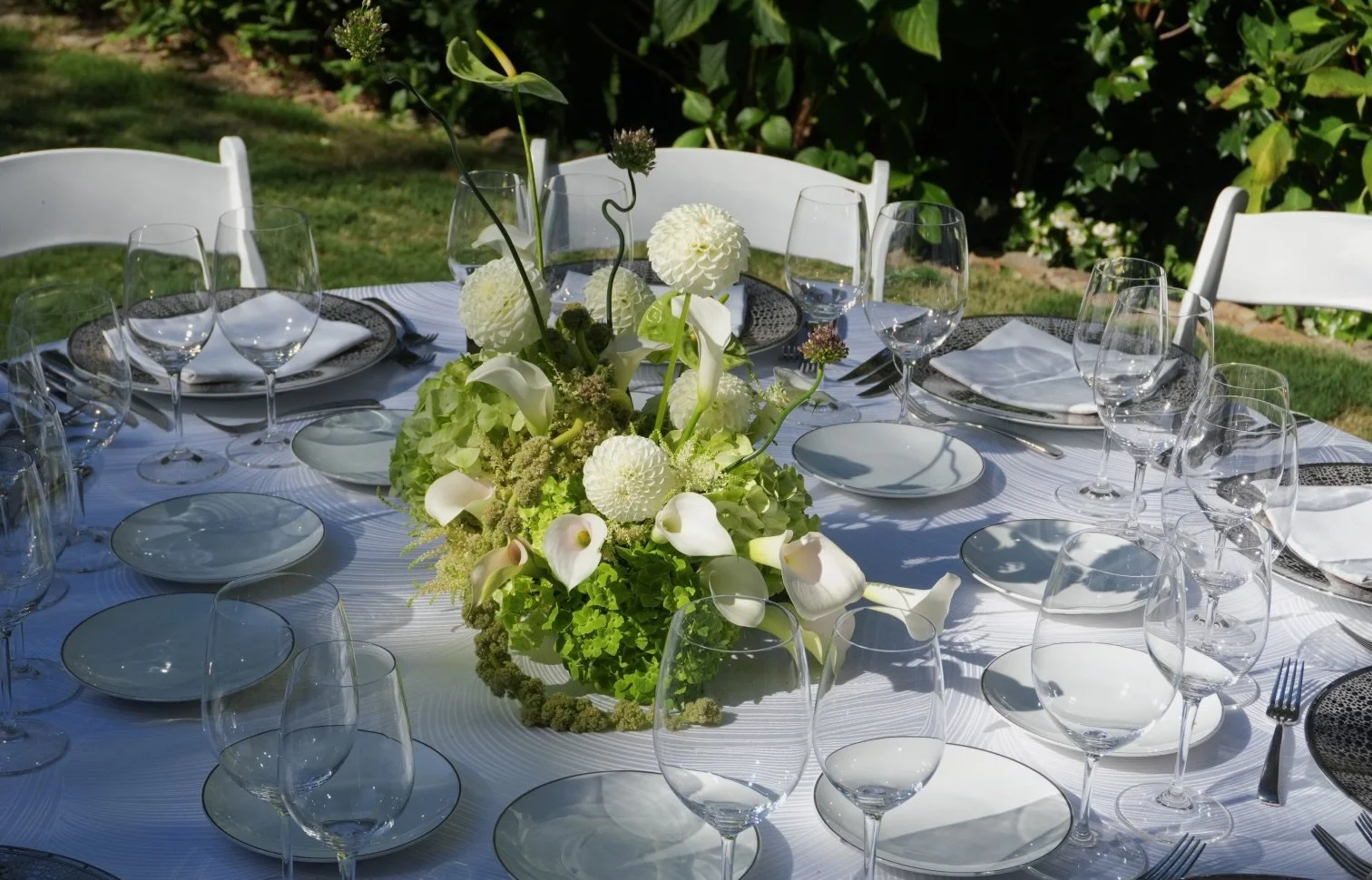 Green and white floral centerpiece for a private dinner.jpeg