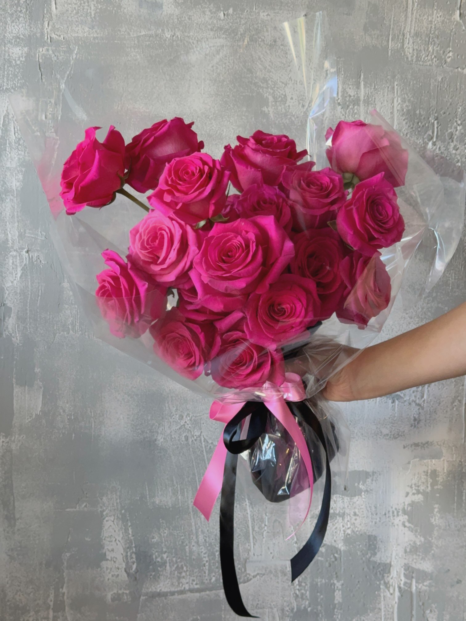 Pink Floyd rose bouquet wrapped in clear paper.jpeg