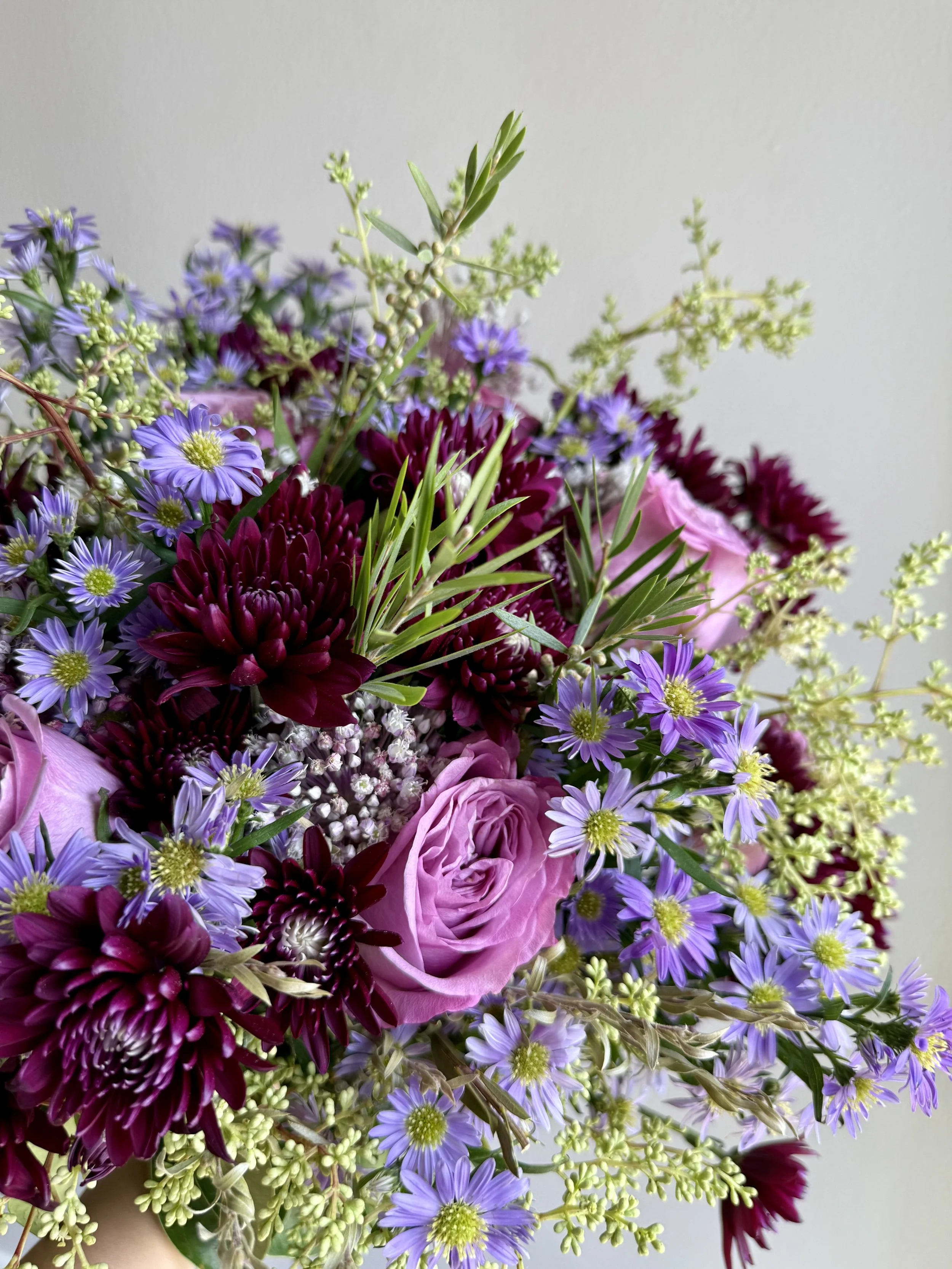 Seasonal bouquet with cool-toned flowers and soft greenery, styled for Girl and the Flower