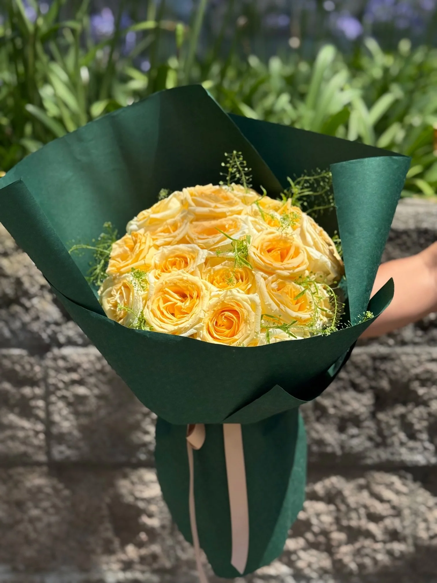 girl-and-the-flower-yellow-rose-bouquet-green-wrap-los-angeles.jpeg