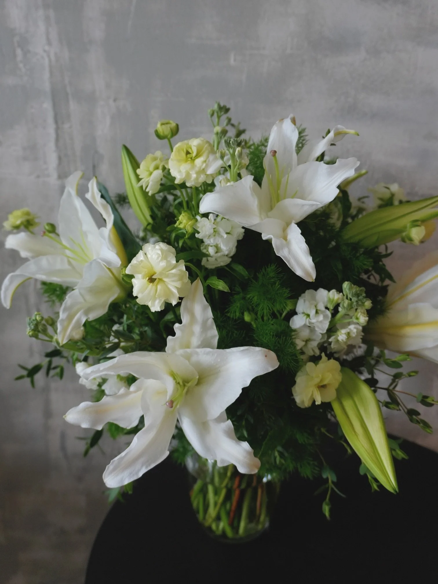 Modern white lily table arrangement.jpeg