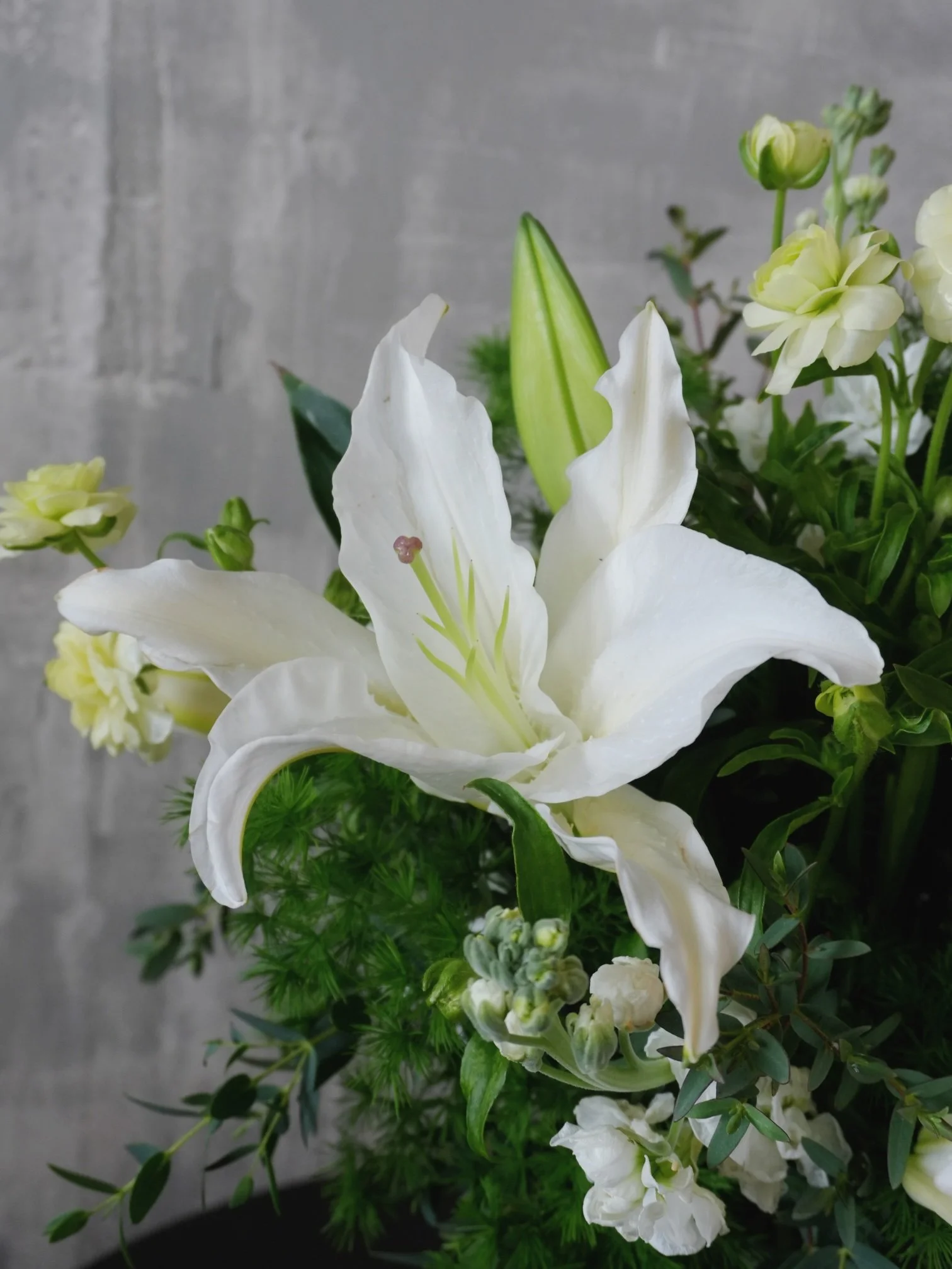 White lily bouquet detail with greenery.jpeg