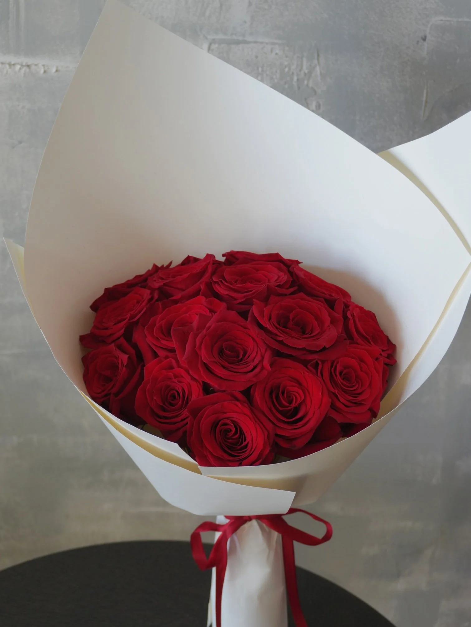 Red roses bouquet minimalist wrapping.jpeg