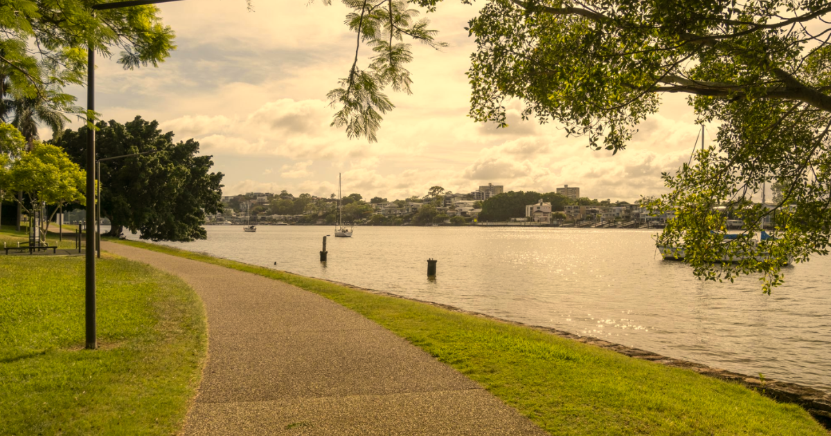 Brisbane River pathway beside calm water, for an article on anger and the nervous system by a somatic counsellor.