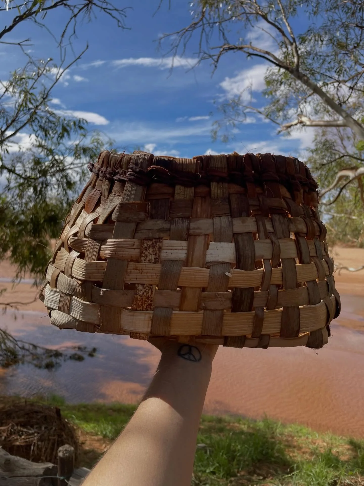 Simple palm sheath basket. 
Perfectly light weight for my son to pull around with his toys. 
This time I did a looser weave to allow the dirt to fall out