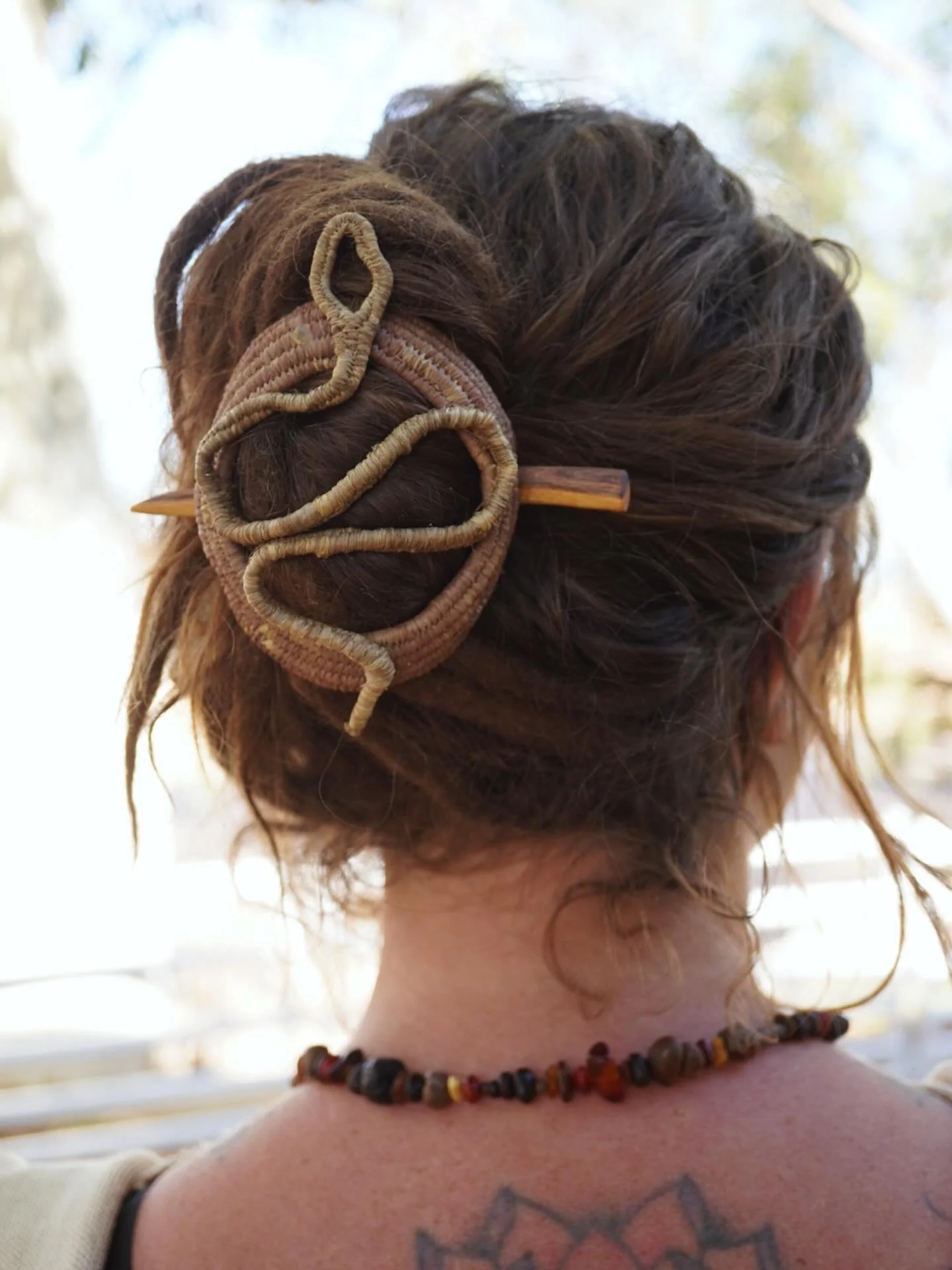 I really love these hair pieces. I love how they look and feel in my hair. 

Raffia coil woven dyed with pomegranate skins and iron for green and iron with tannin for the brown