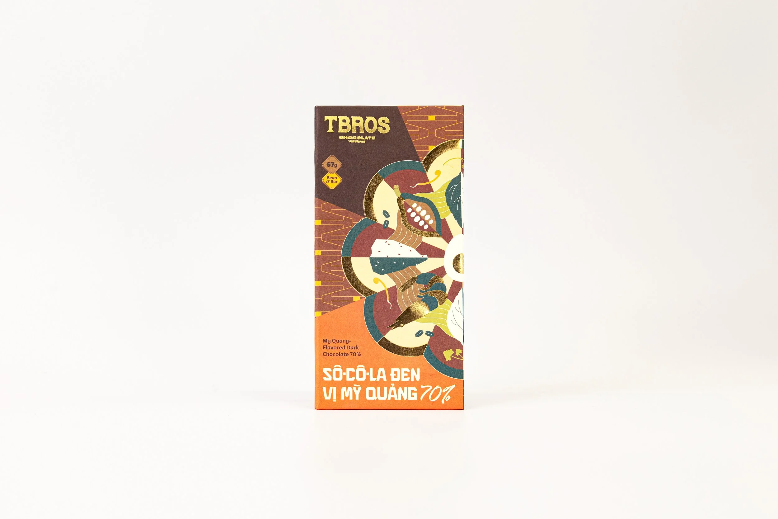 A rectangular chocolate bar package with colorful abstract illustrations and Vietnamese text, labeled 'TBROS' and 'Sô-Cô-La Đen Vị Mỹ Quảng 70%.'