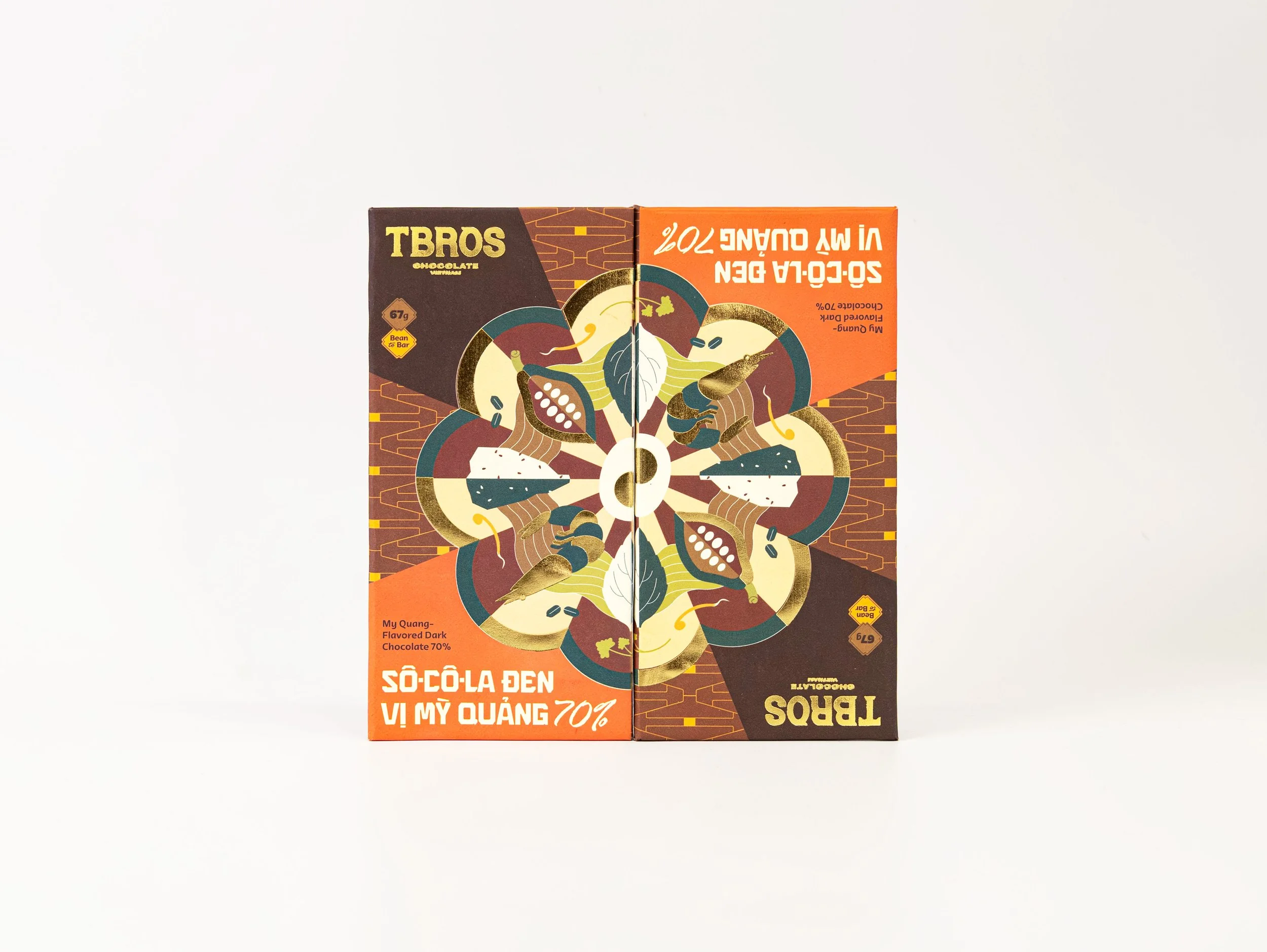 Packaging of TBROS dark chocolate with artistic design, featuring a symmetrical, colorful pattern of cocoa beans, leaves, and abstract shapes, with text in Vietnamese and English highlighting the flavor as 70% cocoa content.