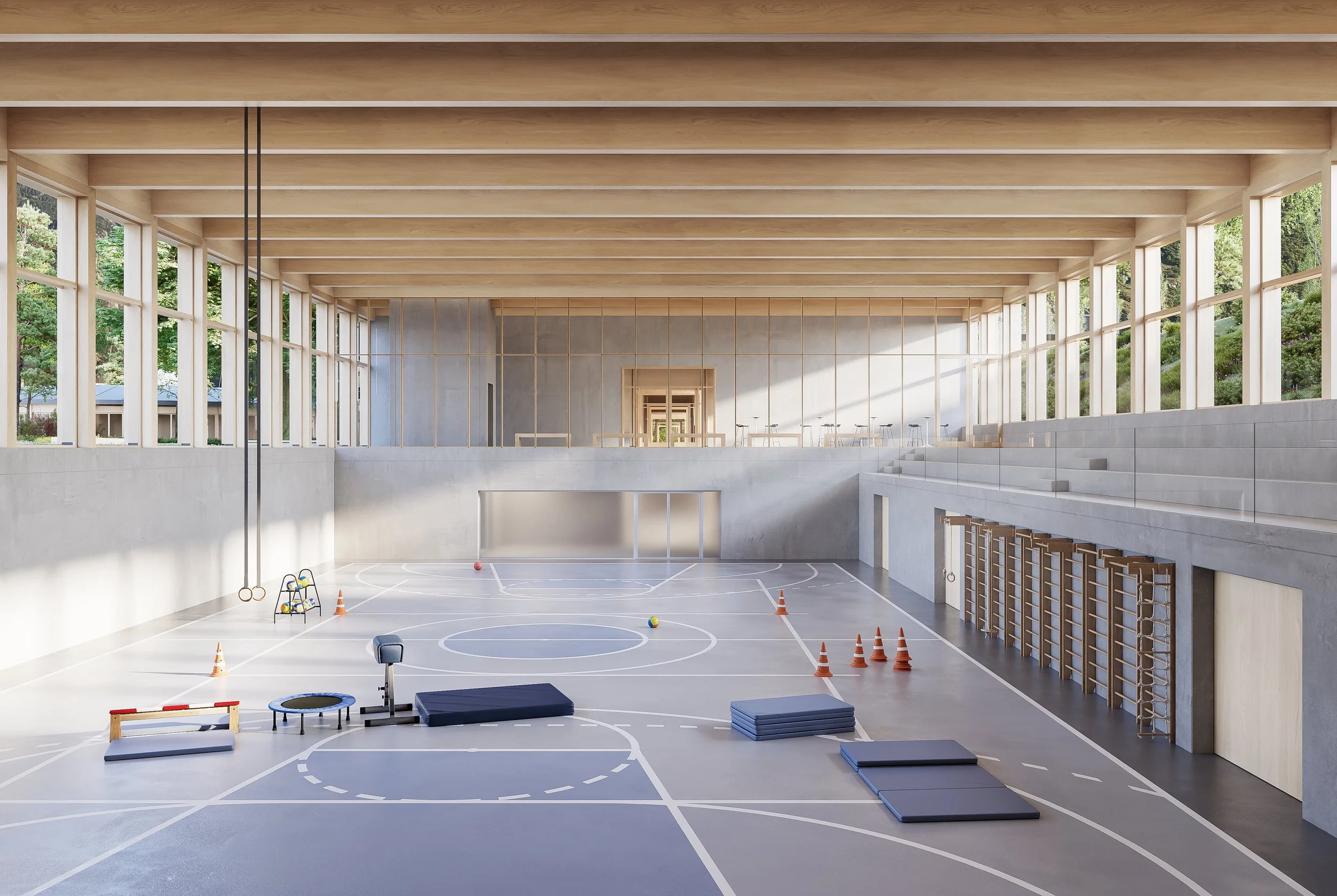 Empty indoor gymnasium with large windows, wooden beams, and sports equipment on the floor, including cones, mats, a trampoline, and gymnastics rings.