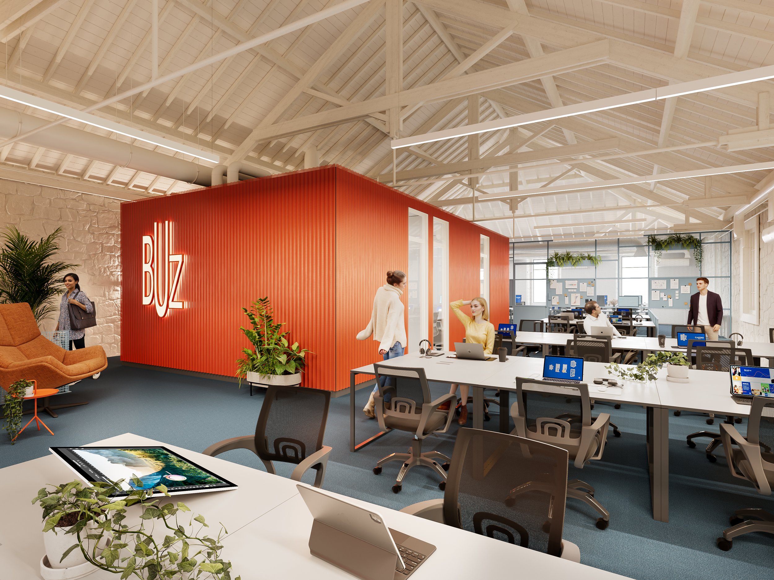 Open office space with multiple work desks, some with laptops, and a bright orange walls with a large BUZ sign. There are several people working and chatting, with plants and modern decor.