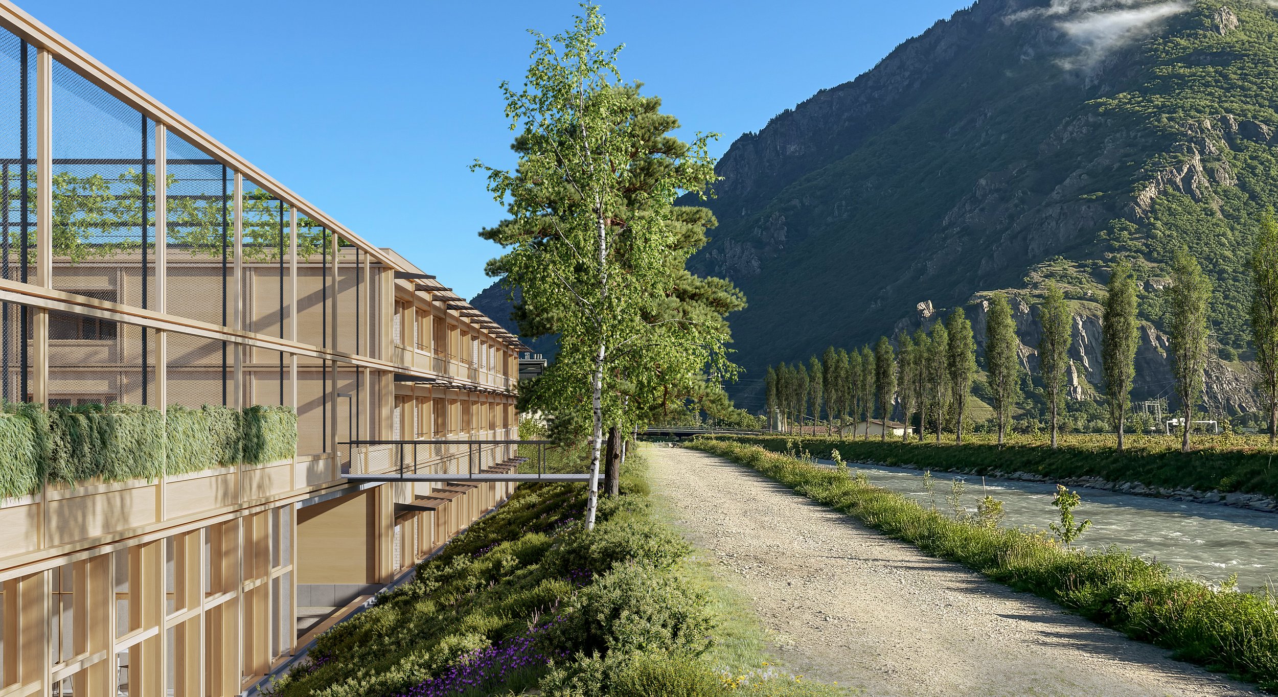 Modern building with glass balconies, lined with trees and greenery, next to a river with a mountain backdrop under a clear blue sky.