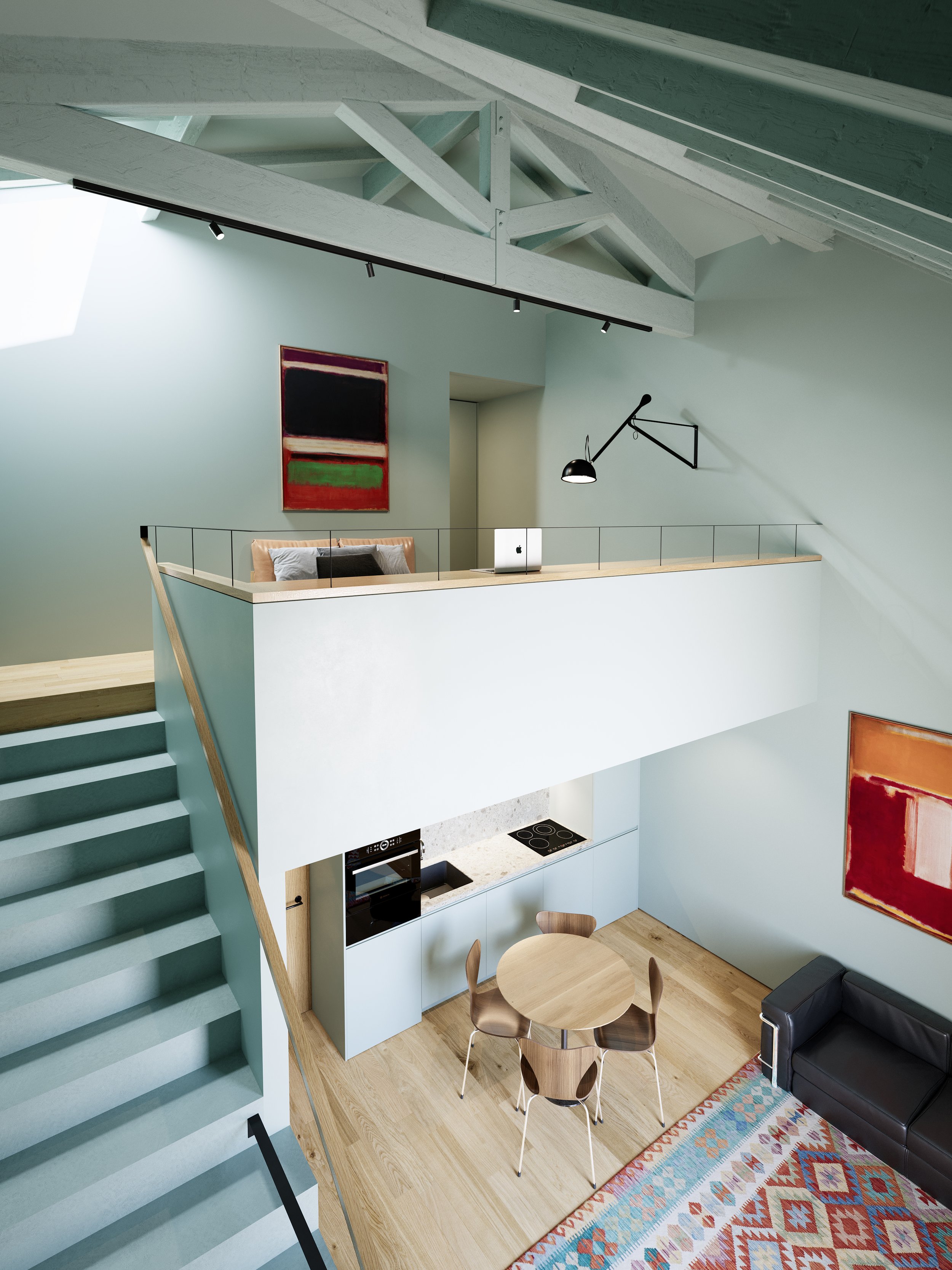 Modern two-story apartment interior with staircase, small kitchen, dining area, and a lofted workspace with a laptop. Minimalist decor and art on the walls.