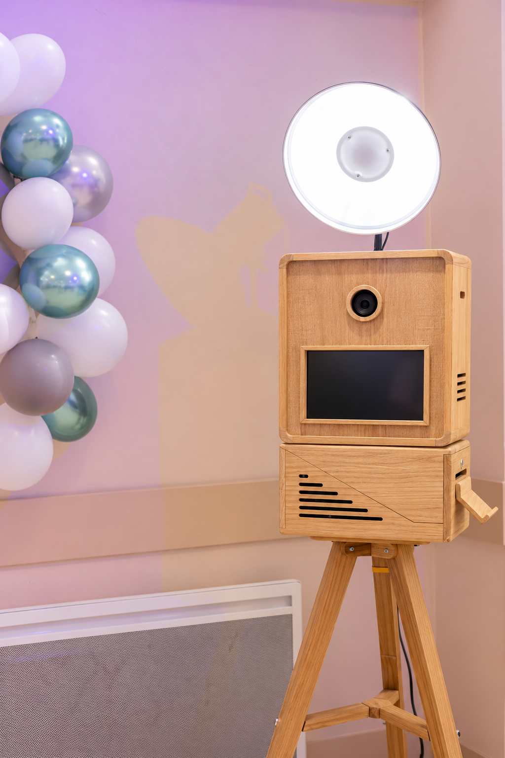 Wooden photo booth under pastel lighting.png