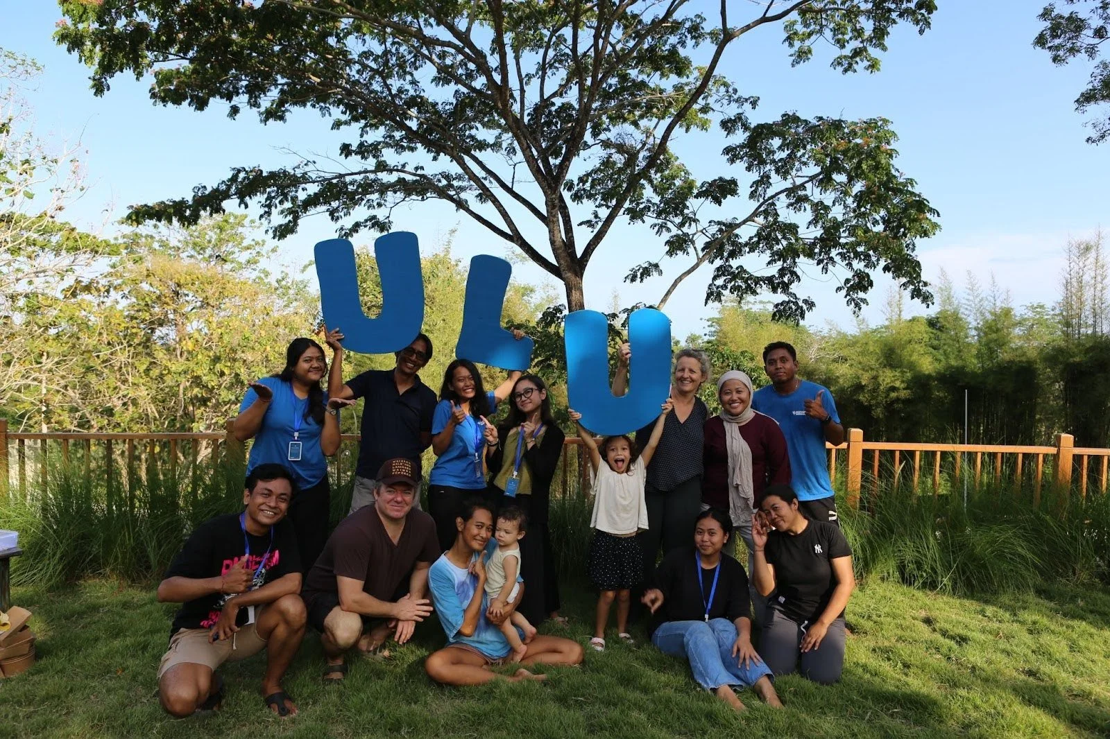 Uluwatu School teachers, families and students posing together during a community gathering in Bali